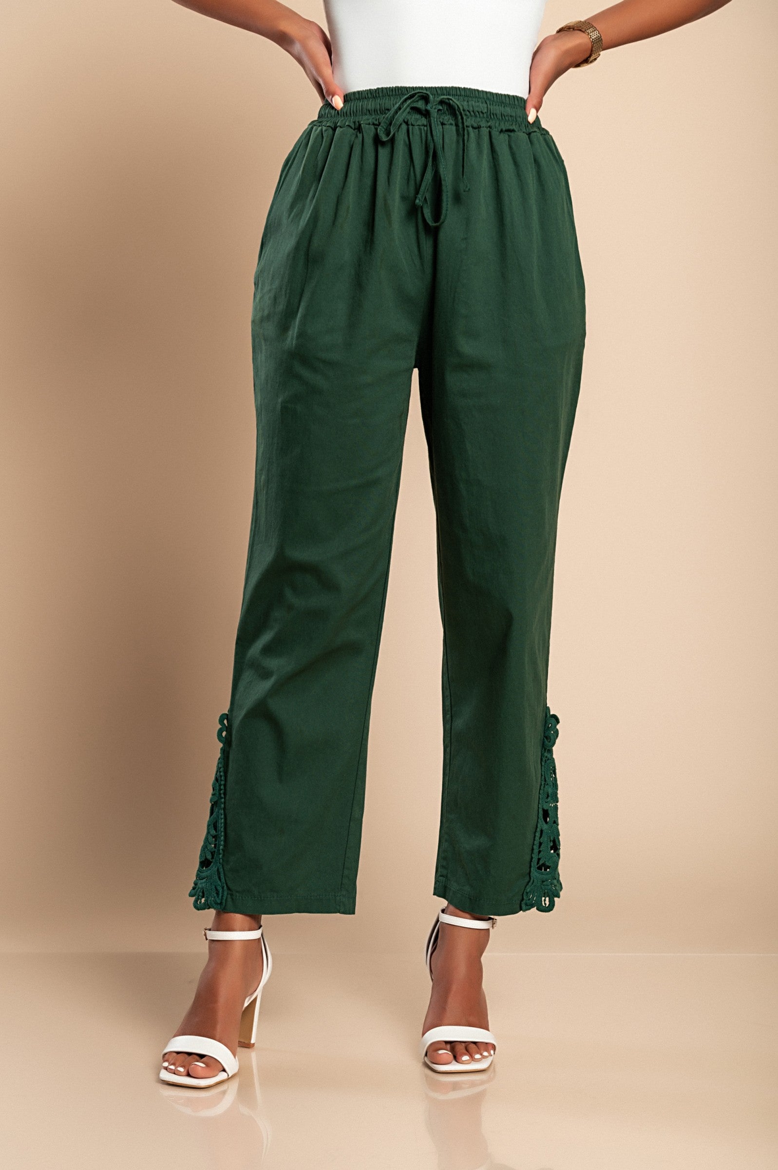 Elegant olive green cotton trousers with lace trim, featuring an elastic and drawstring waist, designed for comfort and style.