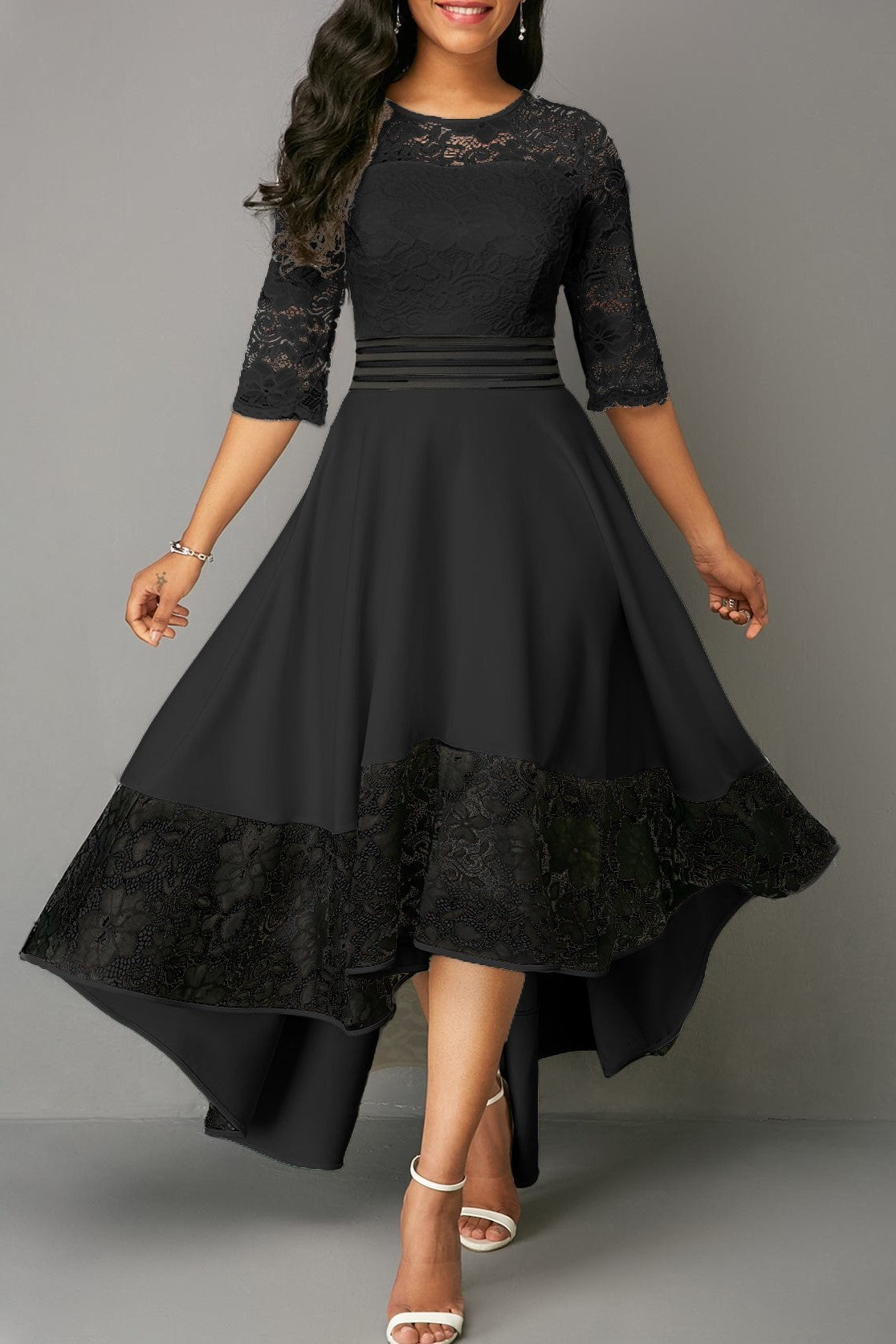 Elegant black dress with lace detailing, featuring an asymmetrical design and sheer 3/4 sleeves, perfect for sophisticated occasions.