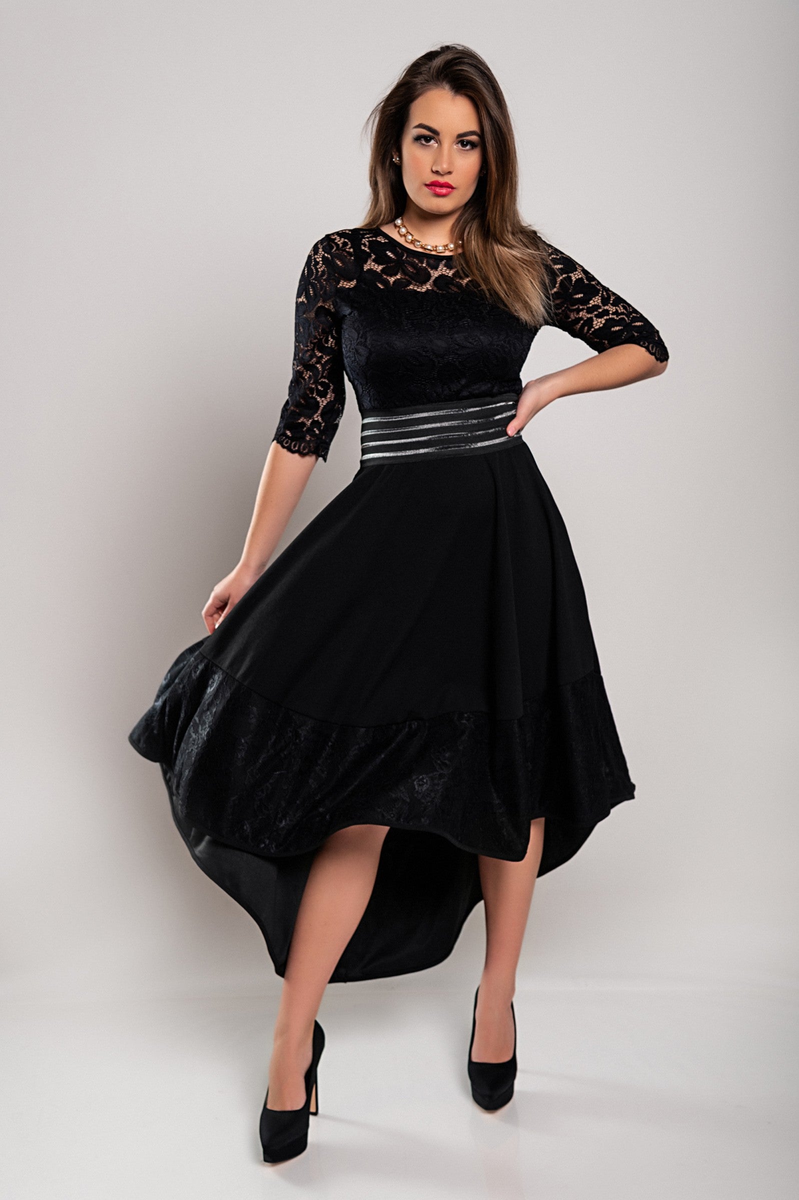 Elegant black dress with lace detailing, featuring an asymmetrical design and sheer 3/4 sleeves, perfect for sophisticated occasions.