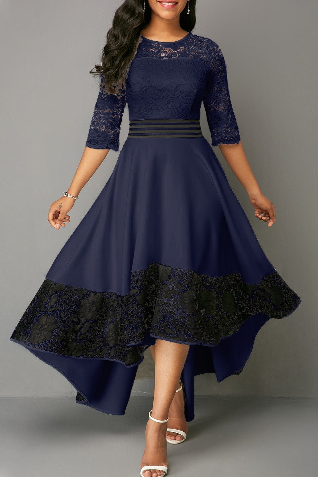 Elegant dark blue dress with lace detailing, featuring sheer 3/4 sleeves and an asymmetrical skirt.