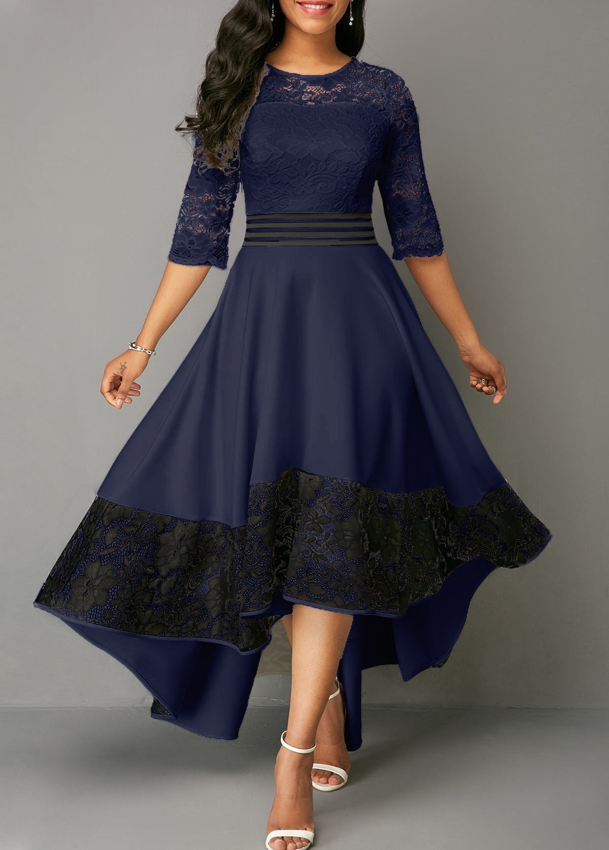 Elegant dark blue lace dress Bianca with asymmetrical design and sheer 3/4 sleeves, featuring a tight waist and lace detailing.