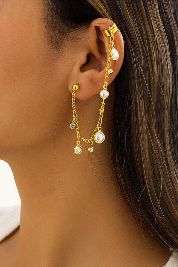 Elegant gold earrings with small chain links and pearl pendants, showcasing a stylish design.