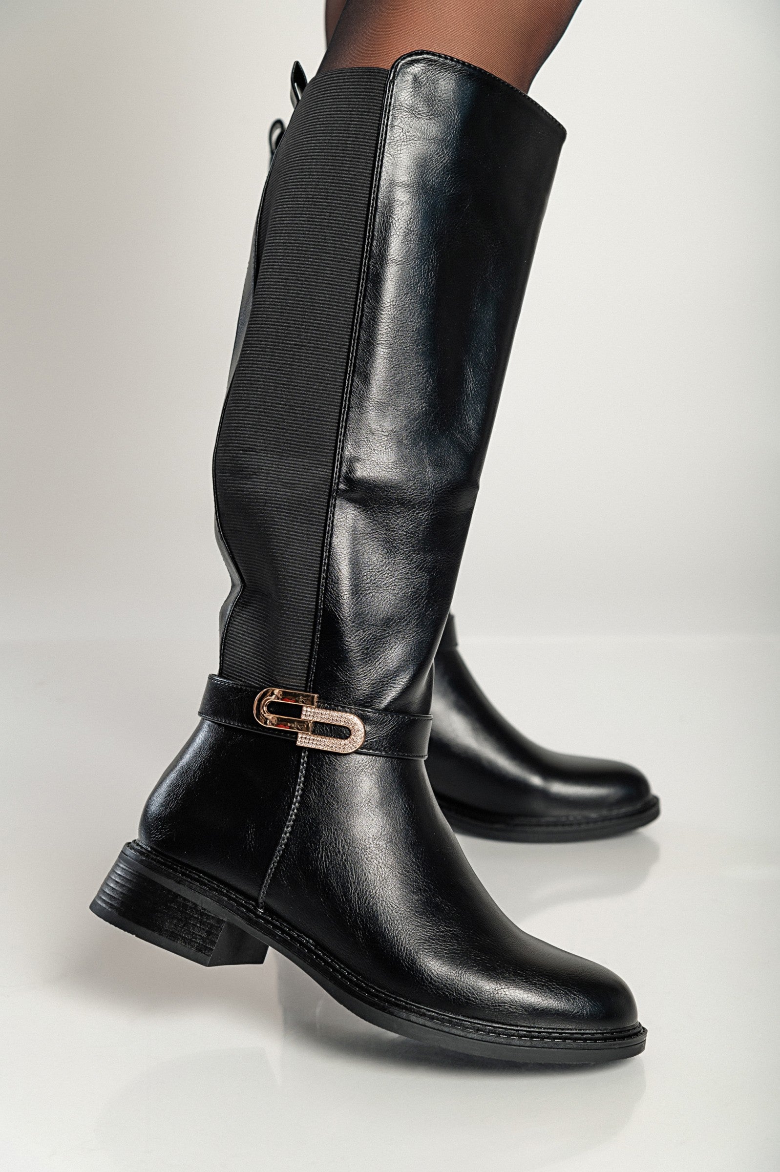 Elegant knee-high faux leather boots in black with a low heel and zip closure, featuring decorative side detail.