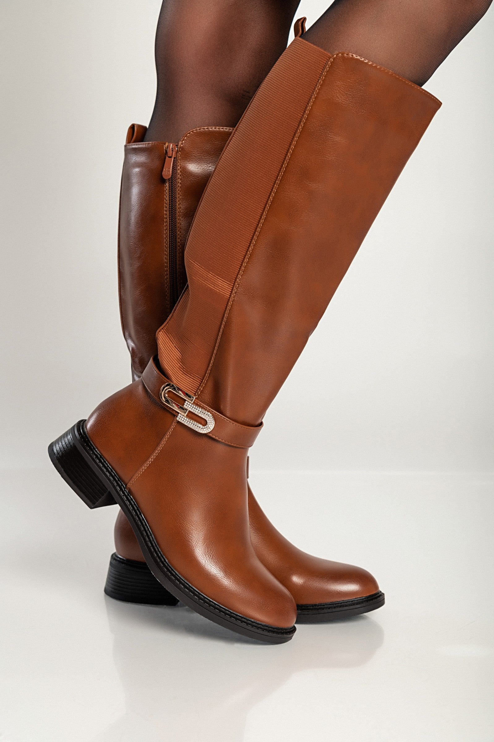 Elegant knee-high faux leather boots in camel color with decorative side detail and zip closure.