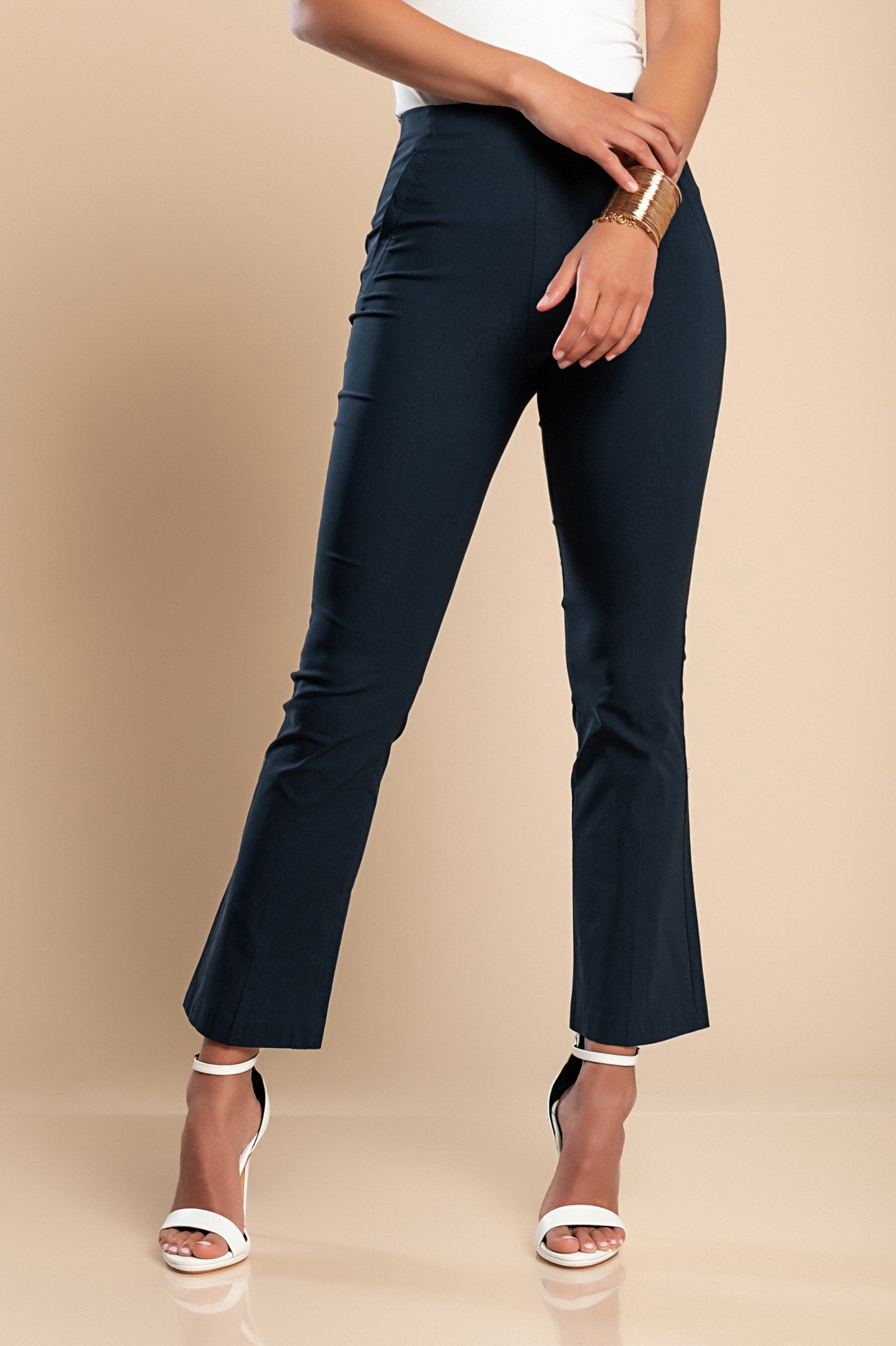 Elegant dark blue flared leg trousers with a middle belt, showcasing a stylish 7/8 length and flared hem, made in Italy.