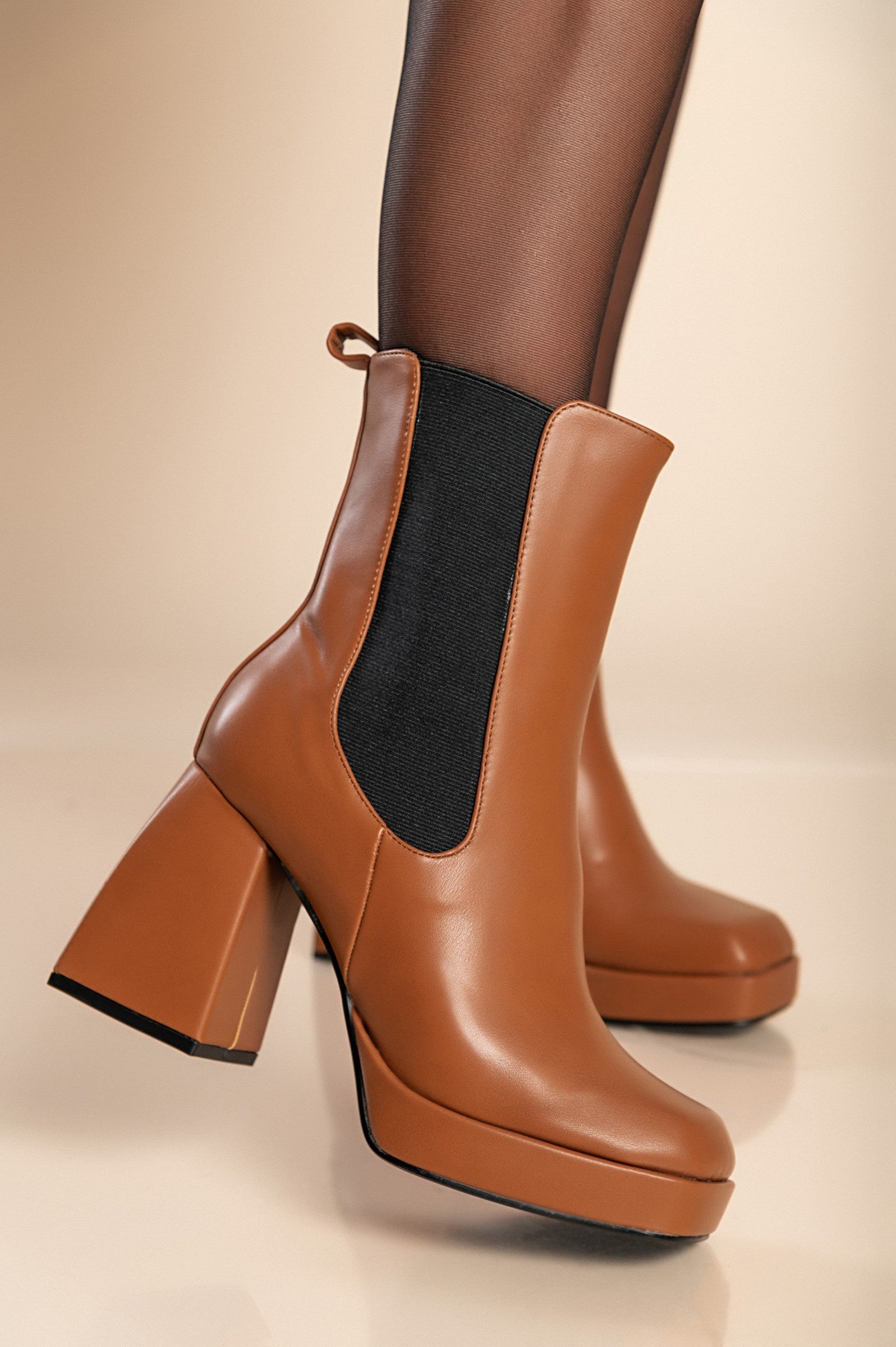 Elegant high-heeled ankle boots in camel color with square toe and interior zipper closure, made from high-quality faux leather.