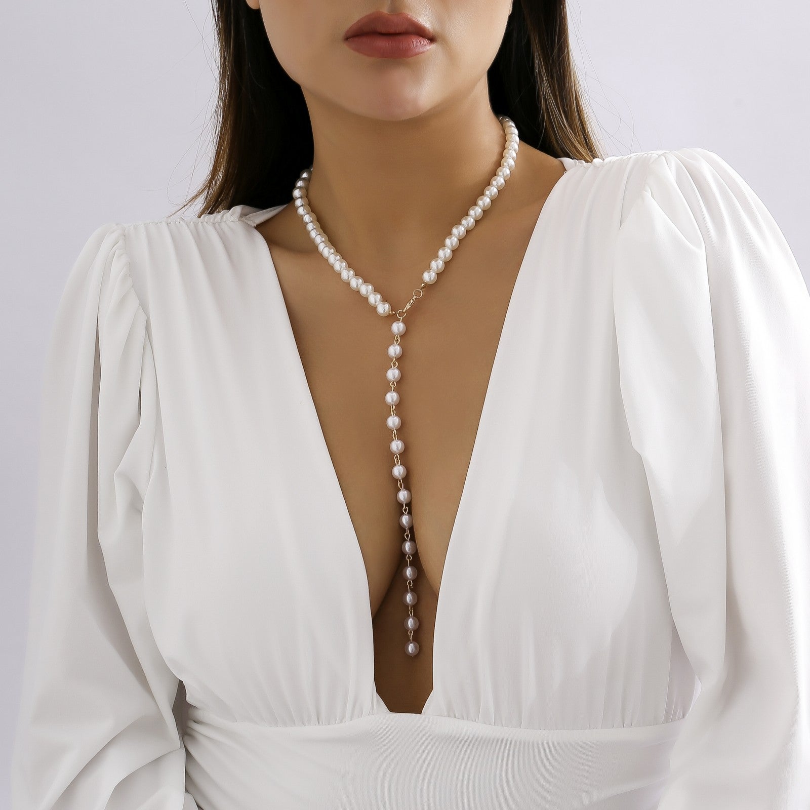 Elegant gold-colored imitation pearl necklace with a lobster clasp closure, showcasing a sophisticated design.