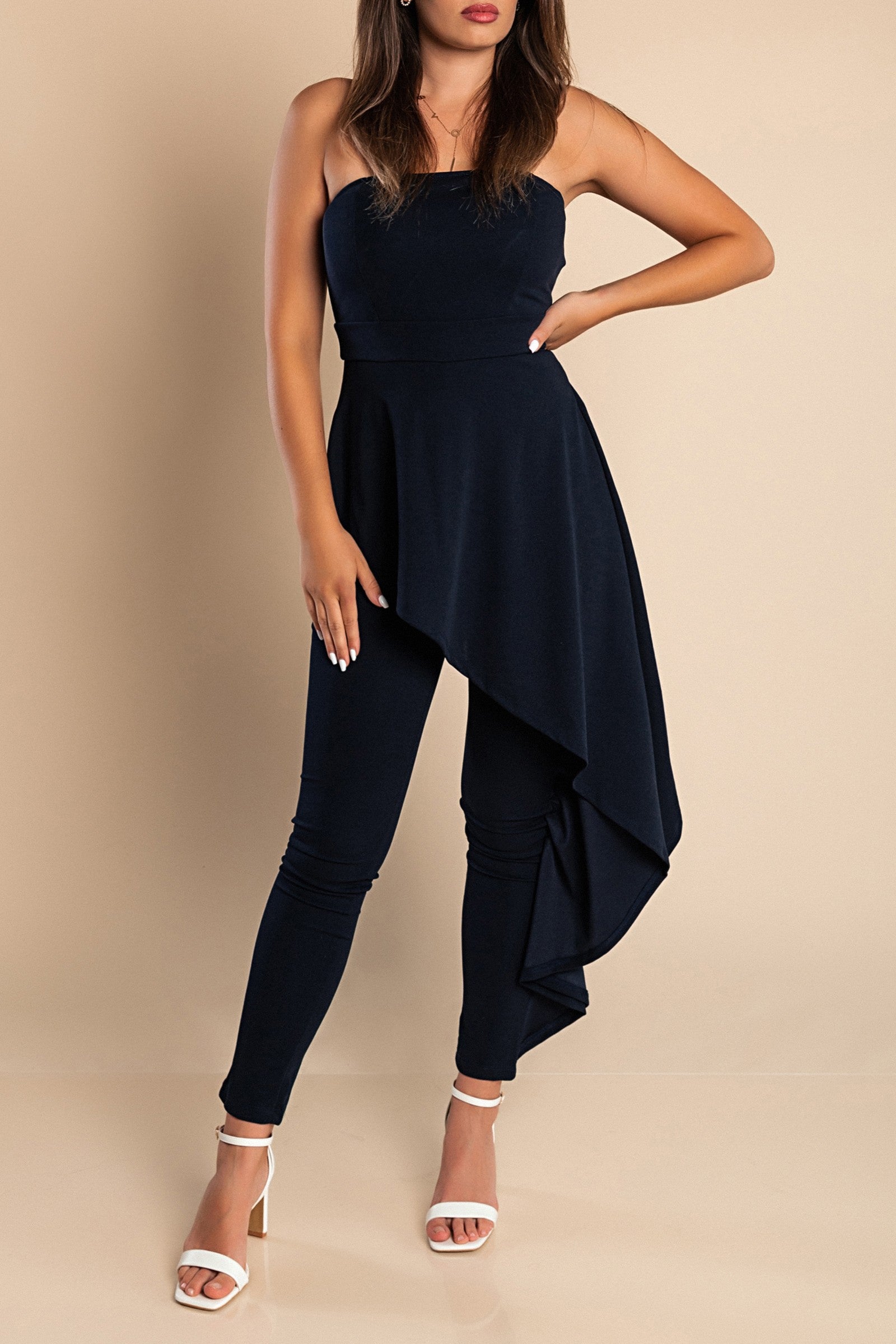 Elegant dark blue jumpsuit Ema with asymmetric skirt detail and zipper closure, showcasing Italian craftsmanship.