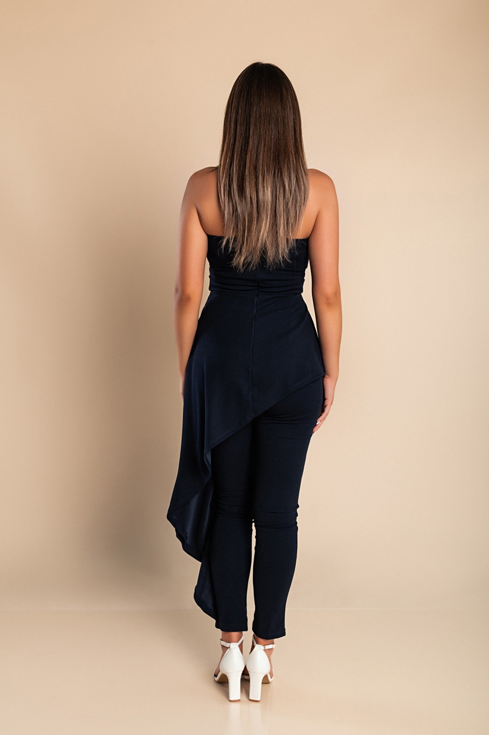 Elegant dark blue jumpsuit Ema with asymmetric skirt detail and zipper closure, showcasing Italian craftsmanship.