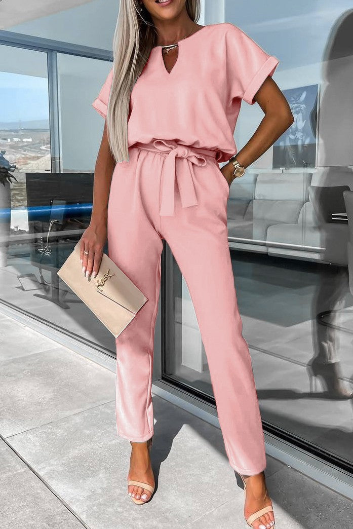 Elegant light pink jumpsuit featuring metallic detail and plunging neckline, perfect for stylish occasions.