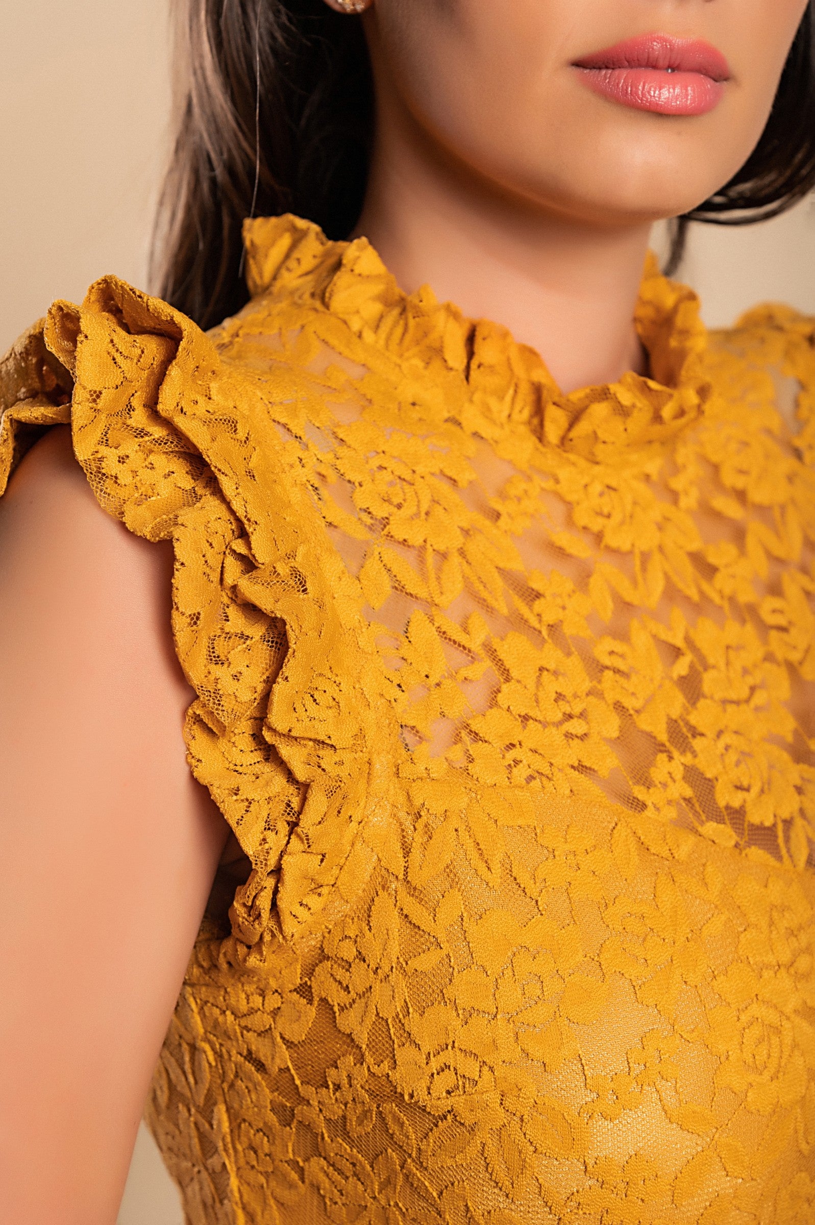 Elegant yellow lace mini dress with ruffled shoulders and high neckline, showcasing a slim-fit design.