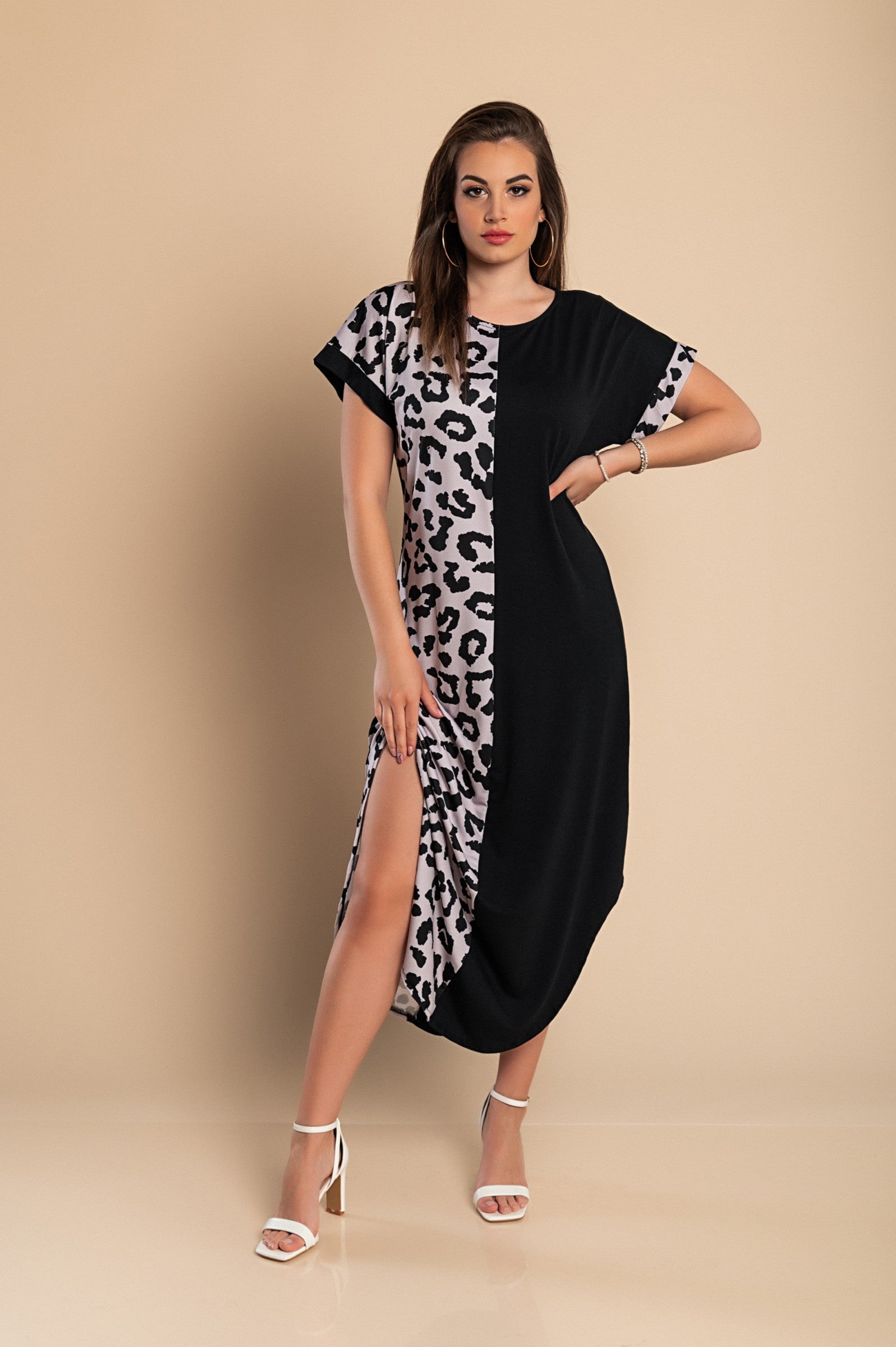 Elegant black maxi dress featuring a stylish leopard print, round neckline, and short sleeves with side slits for added flair.