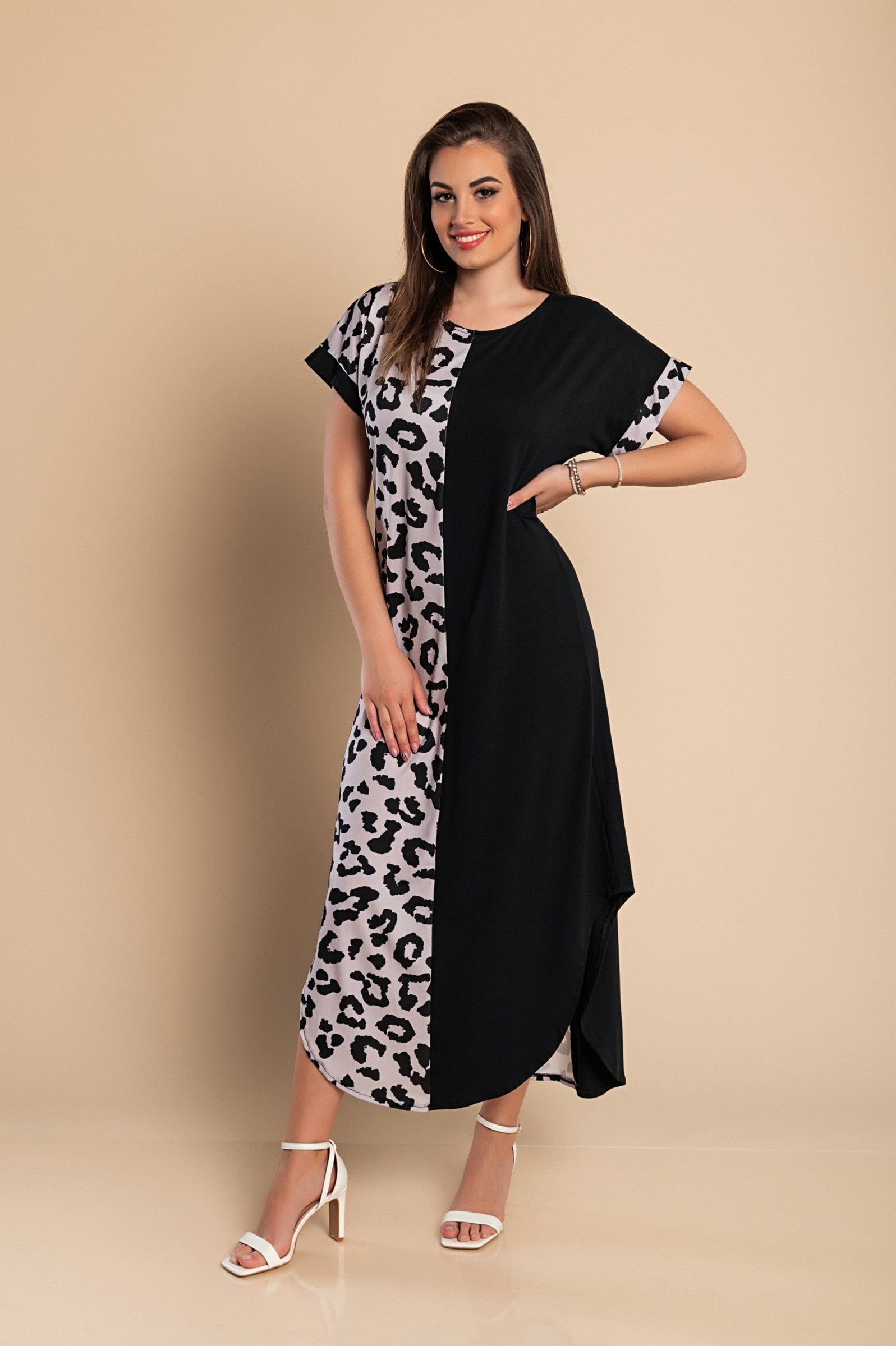 Elegant black maxi dress featuring a stylish leopard print, round neckline, and short sleeves with side slits for added flair.