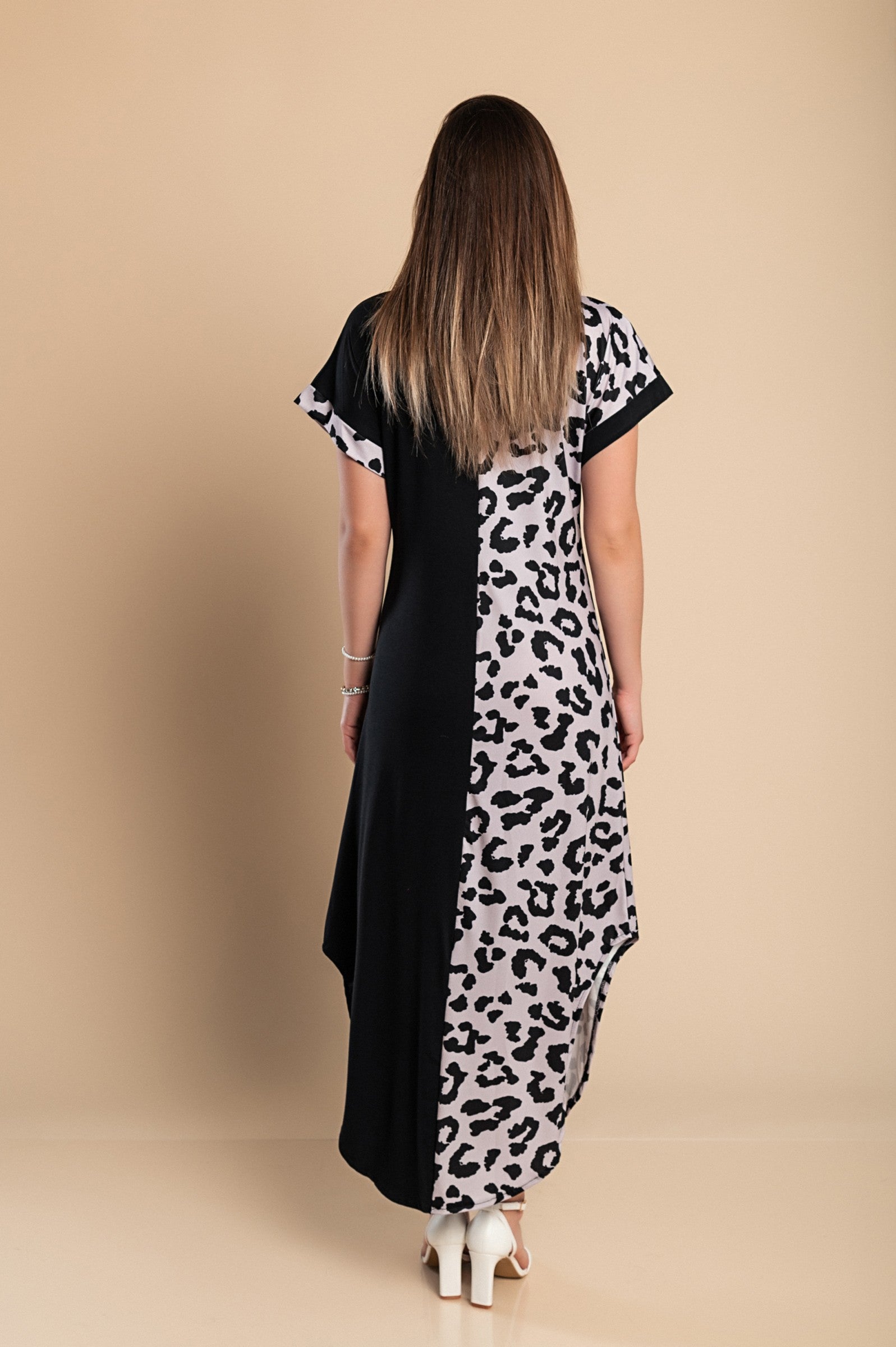 Elegant black maxi dress featuring a stylish leopard print, round neckline, and short sleeves with side slits for added flair.