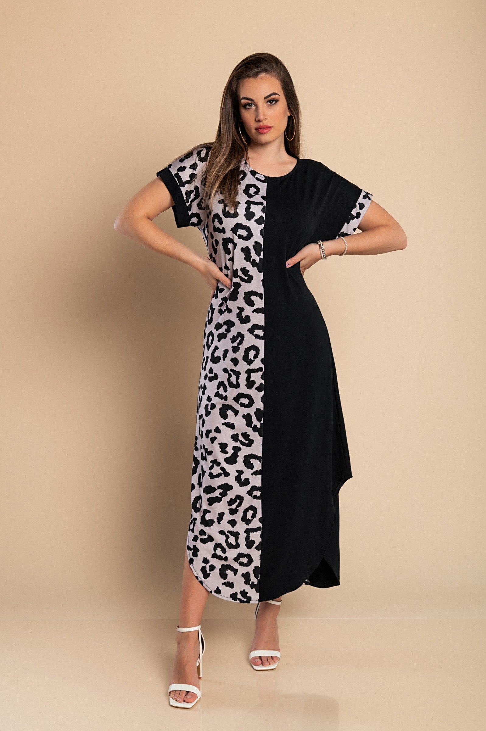 Elegant black maxi dress featuring a stylish leopard print, round neckline, and short sleeves with side slits for added flair.