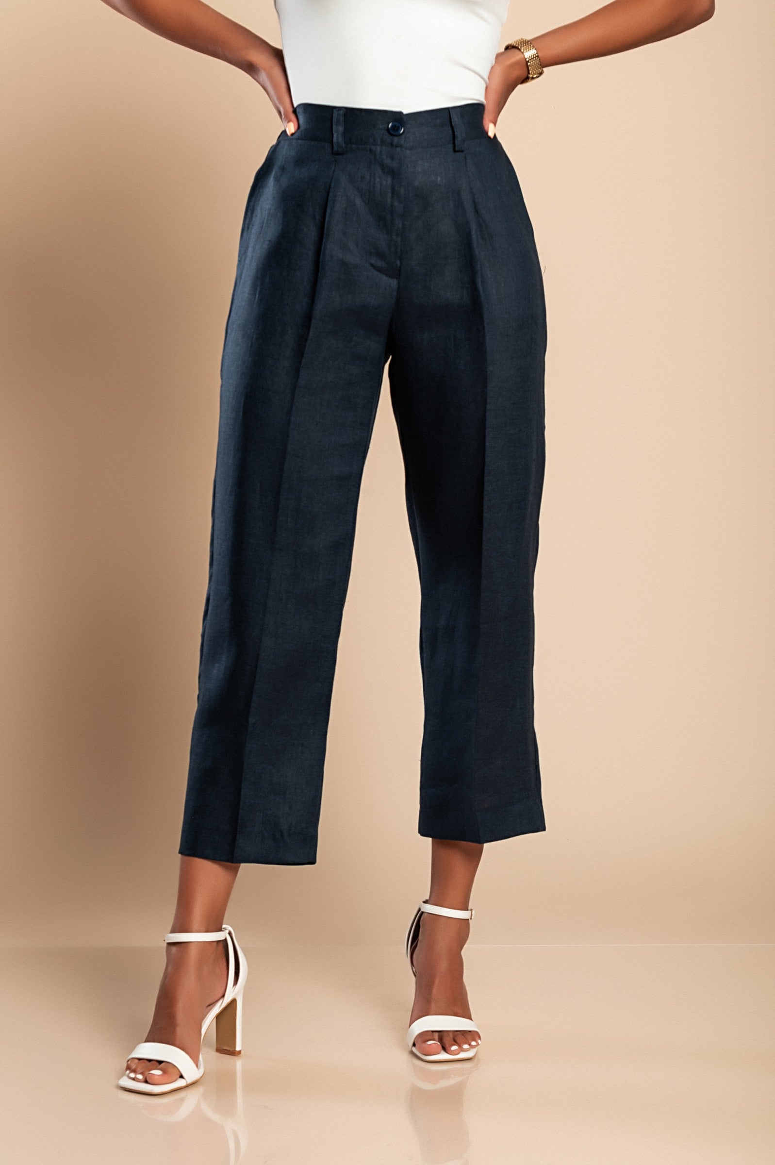 Elegant dark blue linen trousers with elasticated back and side pockets, showcasing a straight-cut design.