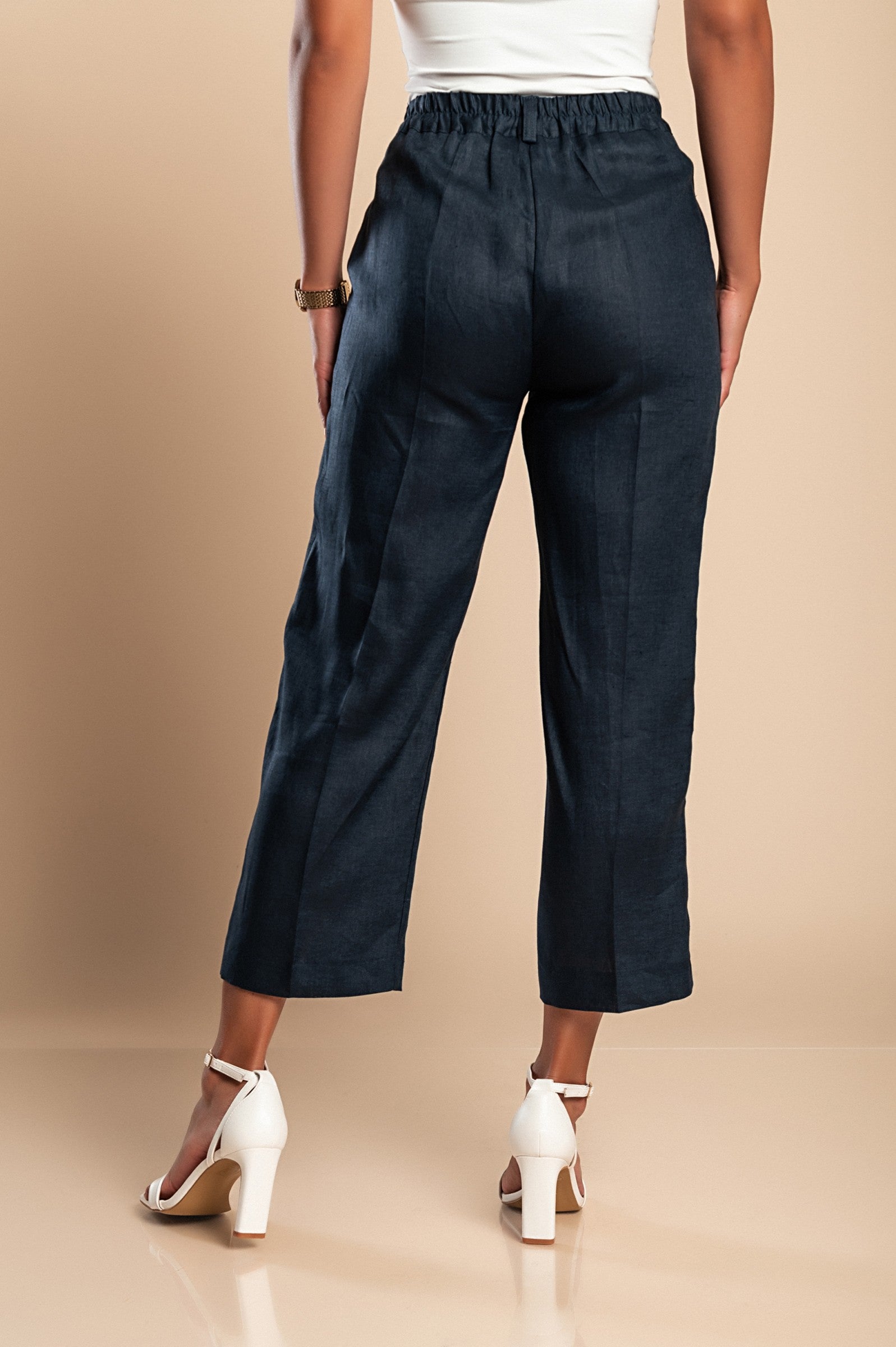 Elegant dark blue linen trousers with elasticated back and side pockets, showcasing a straight-cut design.