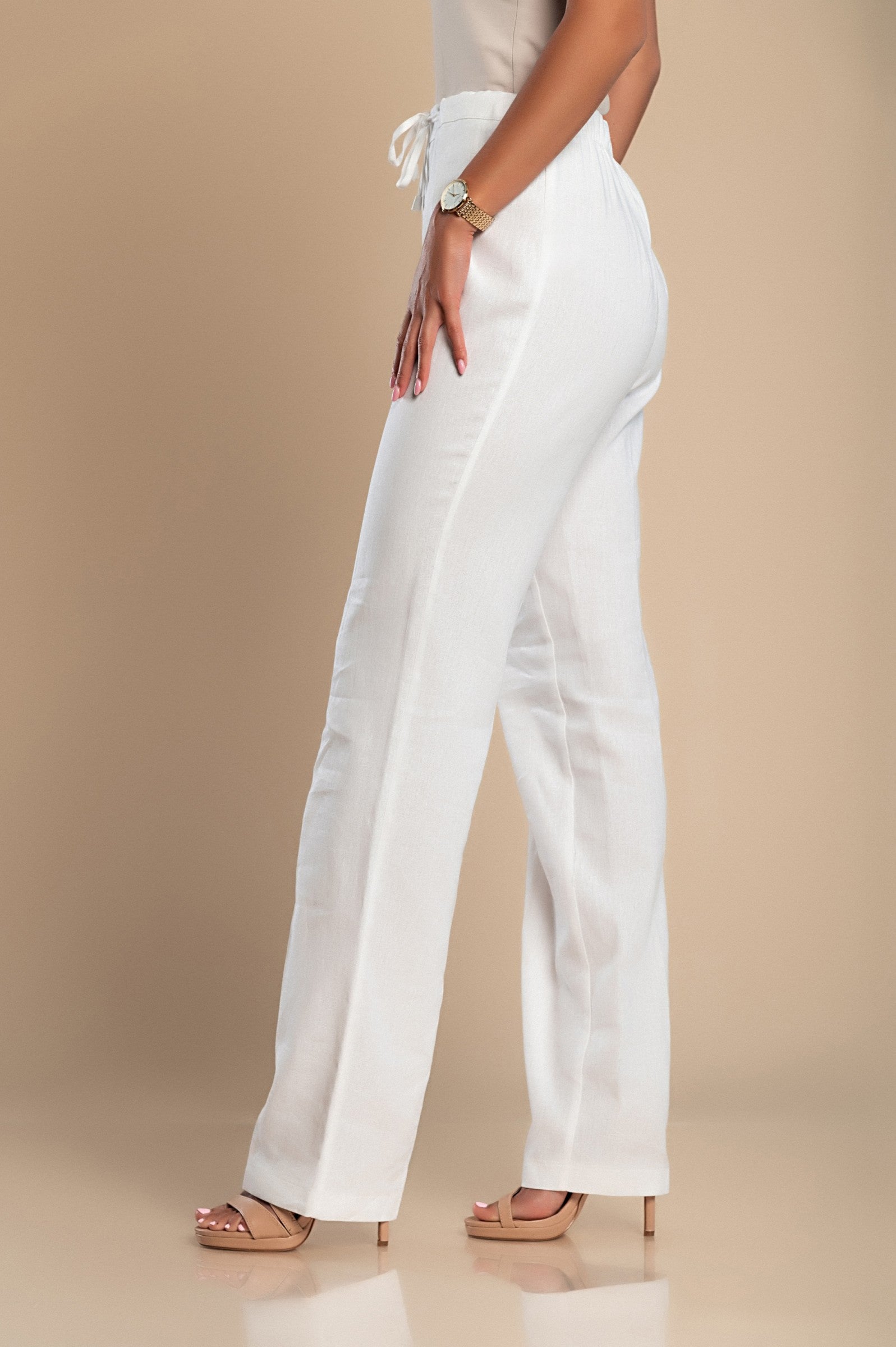 Elegant white linen trousers with a straight cut and drawstring waist, showcasing high-quality Italian craftsmanship.