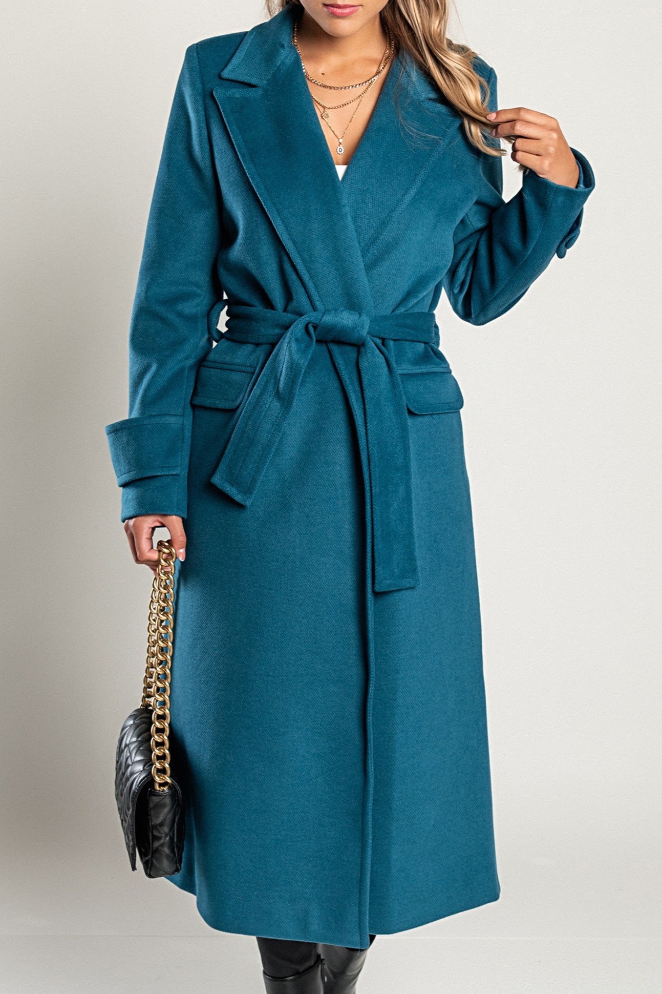 Elegant long coat Canossa in petrol color, featuring a classic collar and decorative belt, made in Italy.