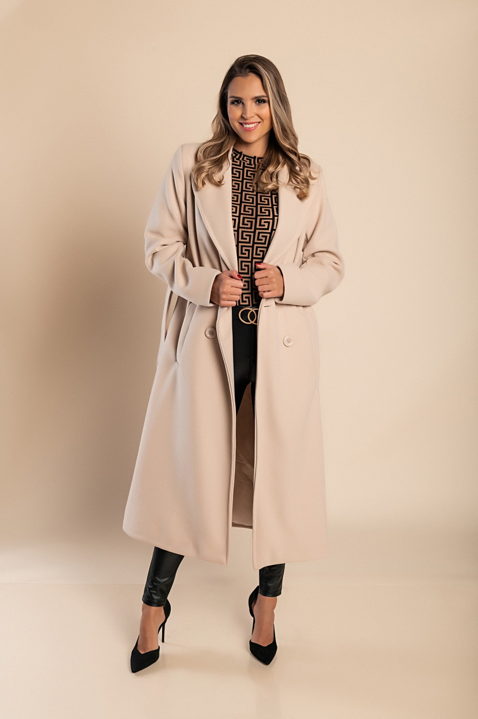 Elegant long beige coat with buttons, featuring a classic collar and decorative belt, made from high-quality soft fabric.