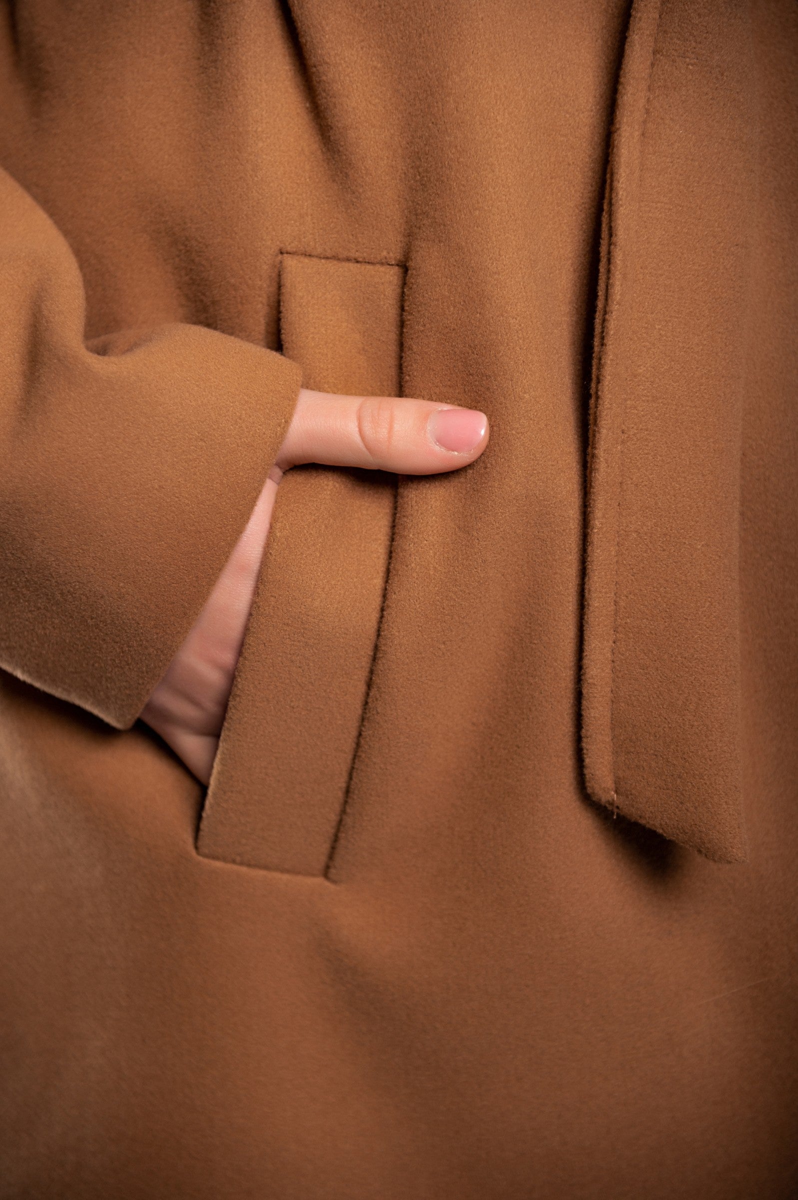 Elegant camel long coat with buttons, featuring a classic collar and decorative belt, perfect for stylish occasions.