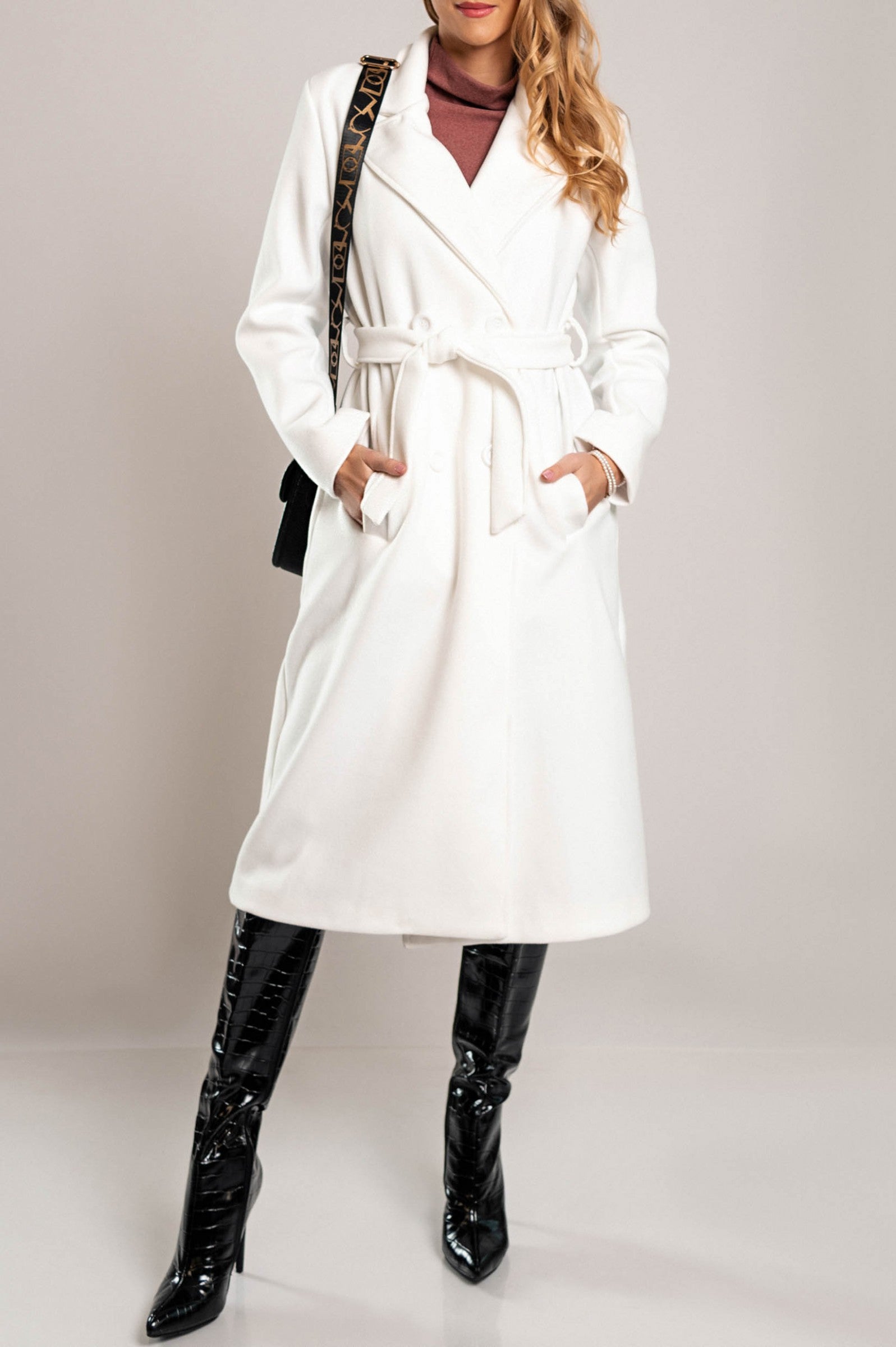 Elegant long white coat with buttons, featuring a classic collar and decorative belt, made from high-quality soft fabric.