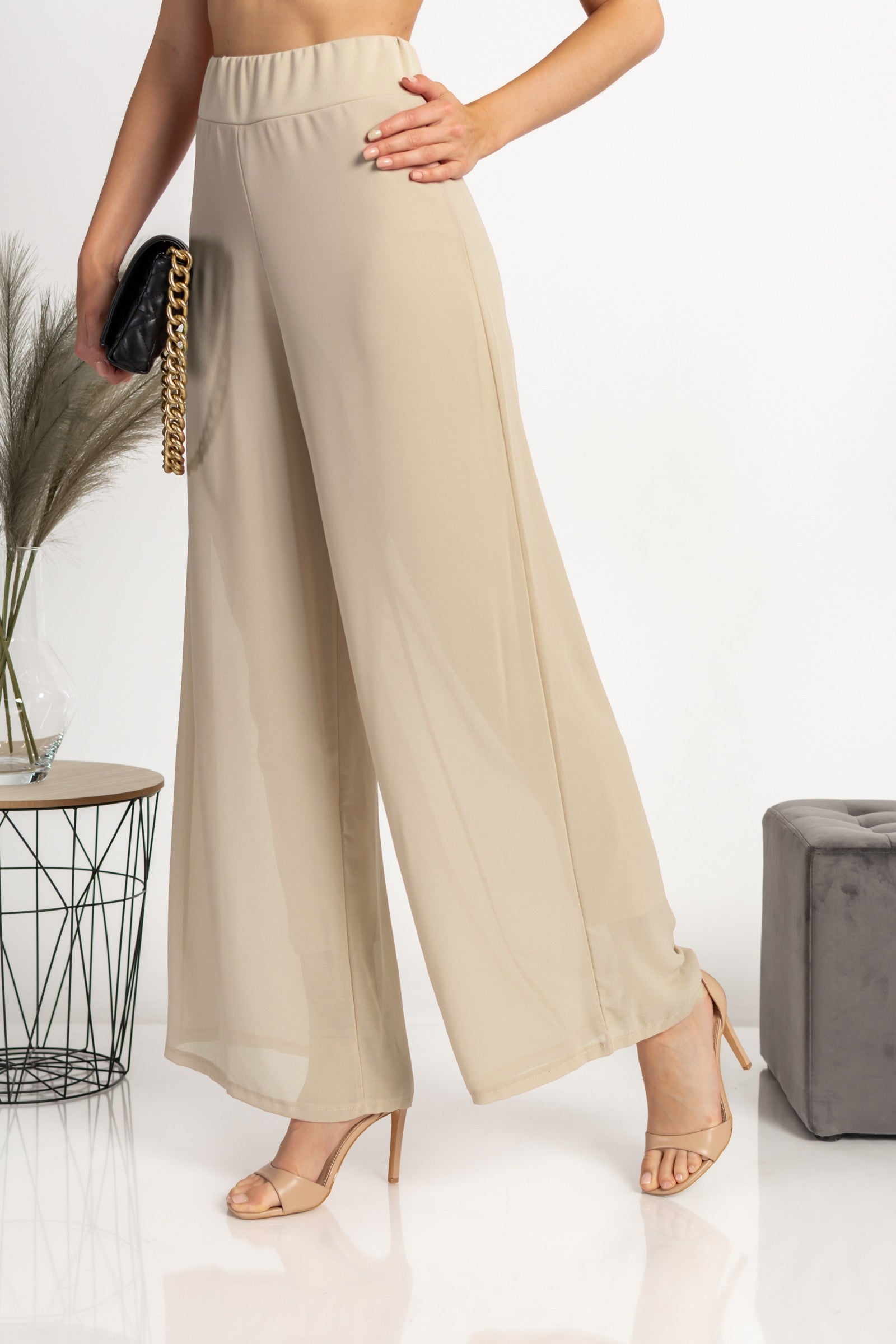 Elegant long beige pants Verona with high waist and sheer top layer, showcasing a loose fit and high-quality fabric.