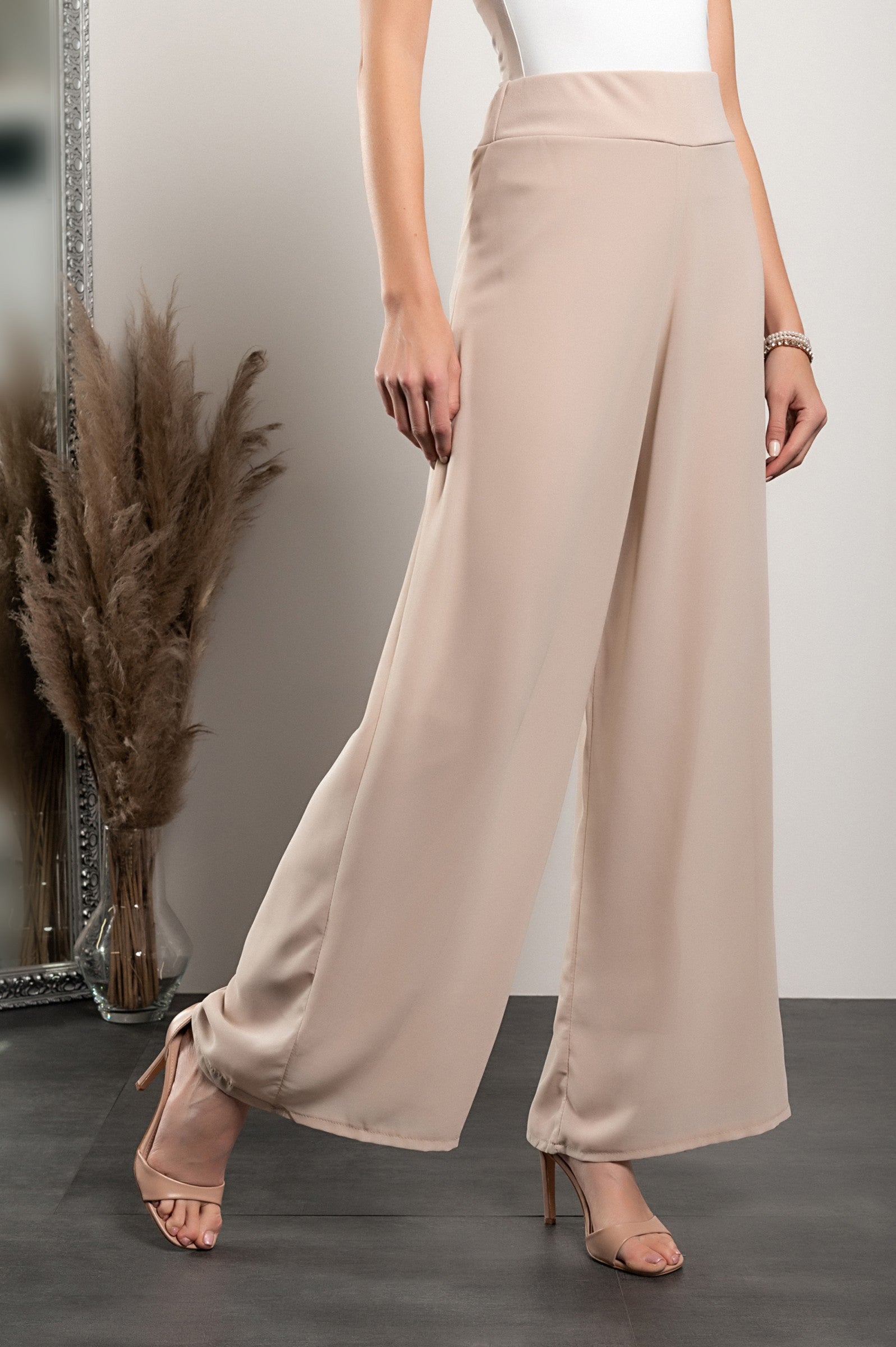 Elegant long beige pants Verona with high waist and sheer top layer, showcasing a loose fit and high-quality fabric.