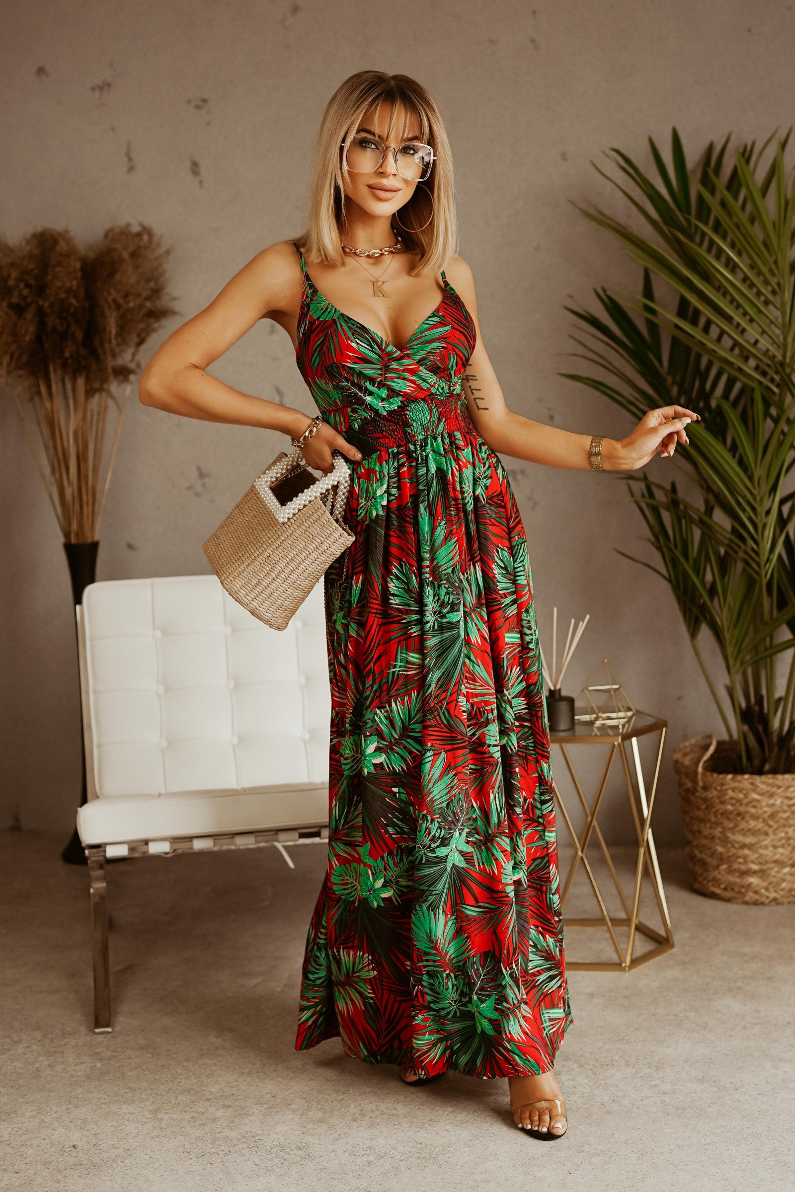 Elegant red maxi dress with tropical print, featuring spaghetti straps and a deep V neckline, perfect for various occasions.