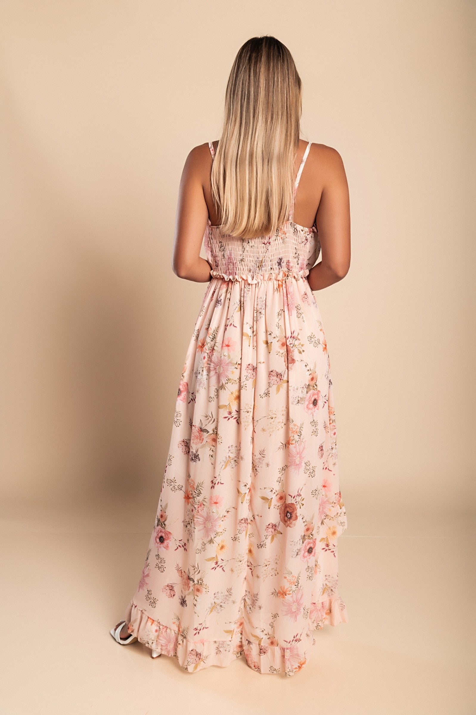 Elegant beige maxi dress with print featuring a plunging neckline, ruffle trim, and asymmetrical skirt with ruffles, designed for comfort and style.