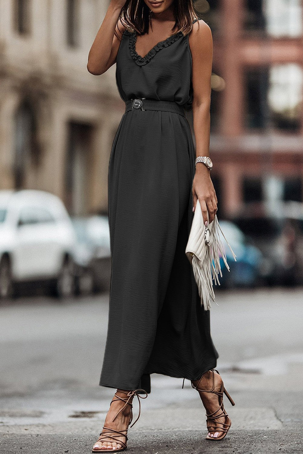 Elegant black maxi dress with ruffles, spaghetti straps, and a loose skirt, showcasing Italian craftsmanship.