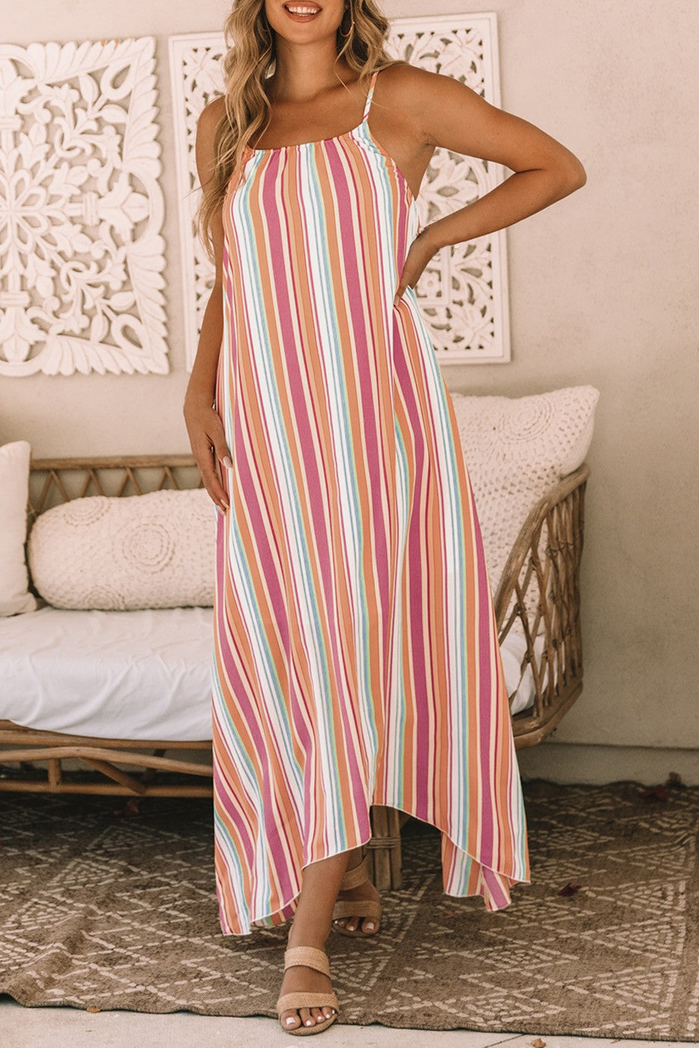 Elegant multicolor maxi dress featuring a striped print, round neckline, and asymmetric hem, made from lightweight fabric.