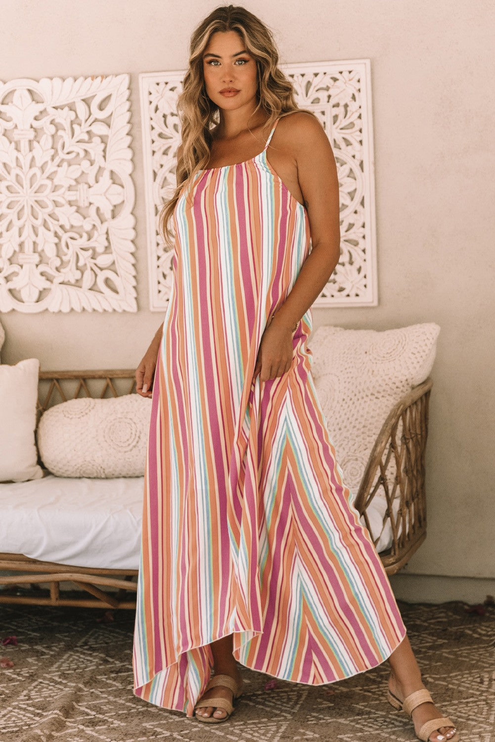 Elegant multicolor maxi dress featuring a striped print, round neckline, and asymmetric hem, made from lightweight fabric.