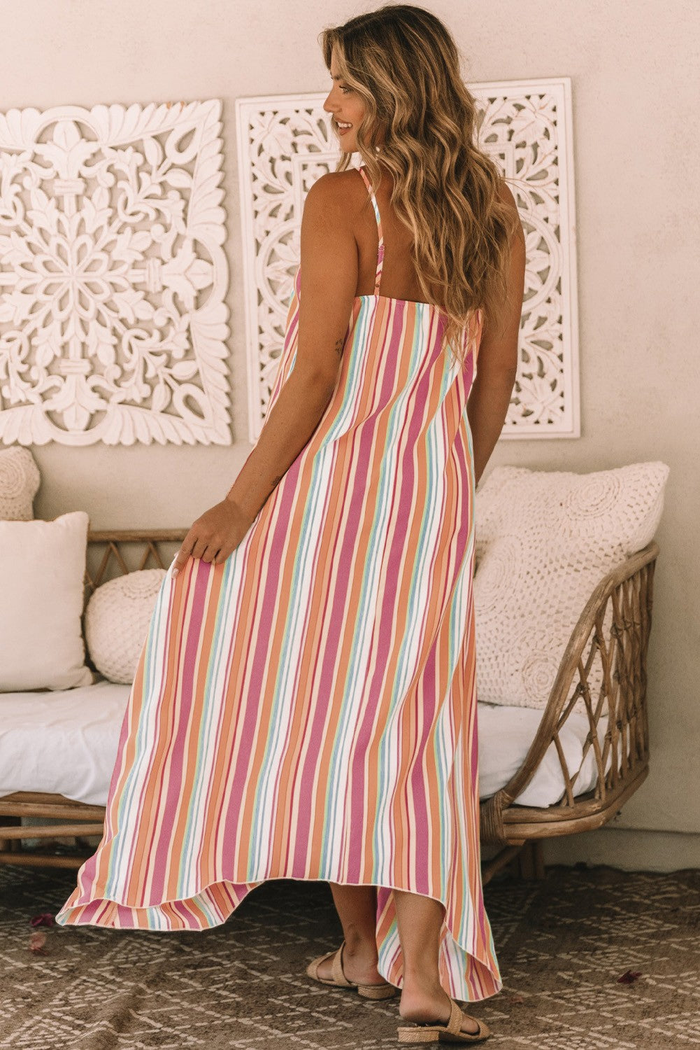 Elegant multicolor maxi dress featuring a striped print, round neckline, and asymmetric hem, made from lightweight fabric.