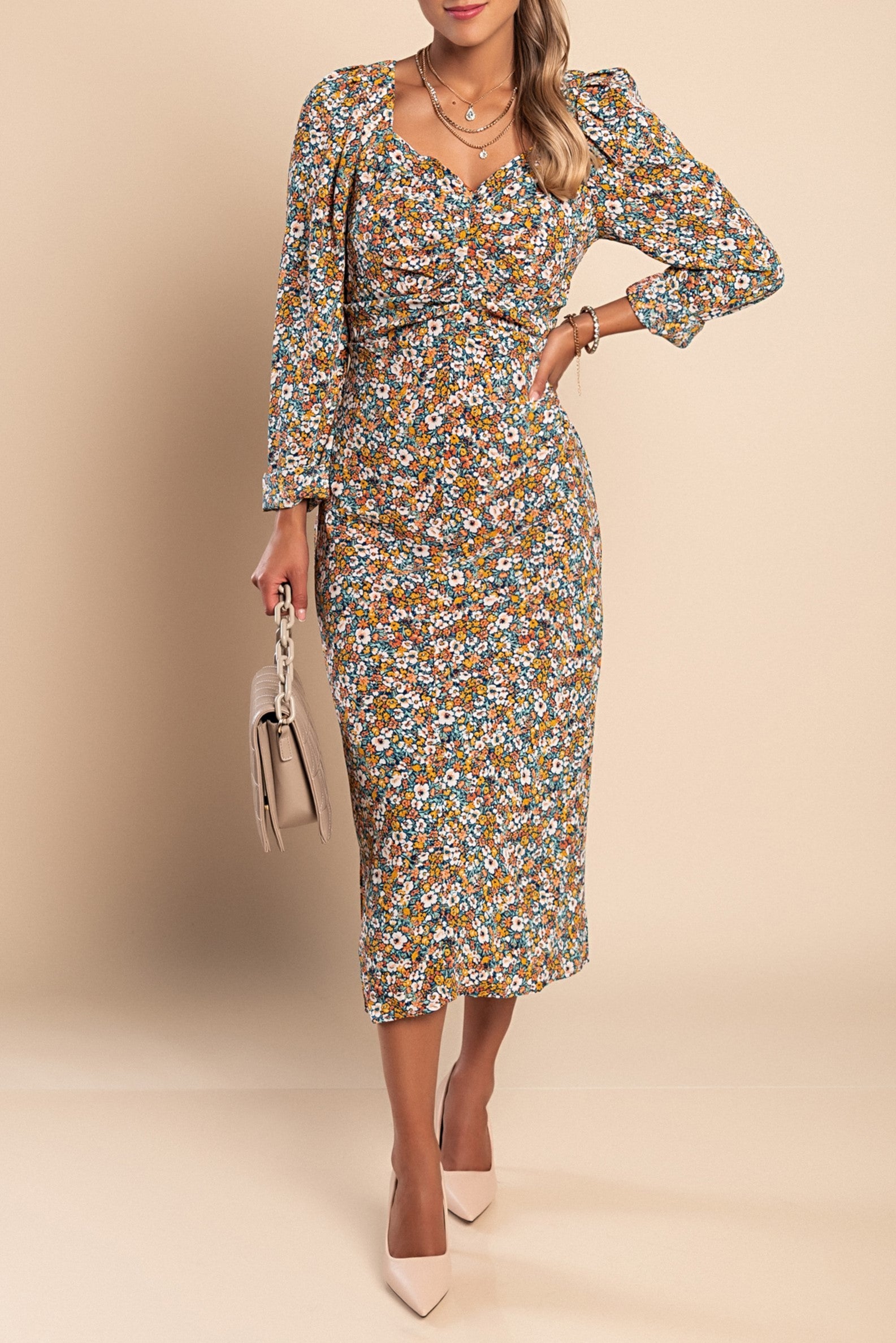 Elegant orange midi dress with floral print, featuring a V-neckline and long sleeves, perfect for various occasions.