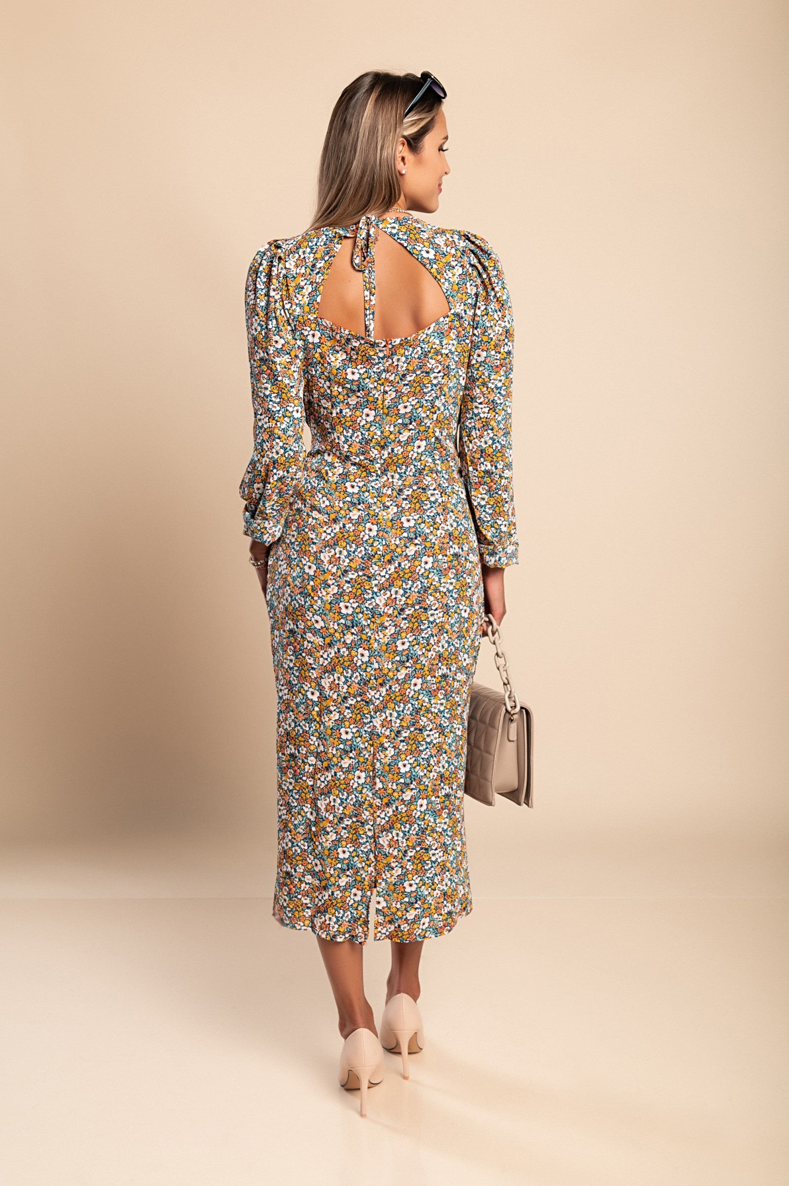 Elegant orange midi dress with floral print, featuring a V-neckline and long sleeves, perfect for various occasions.