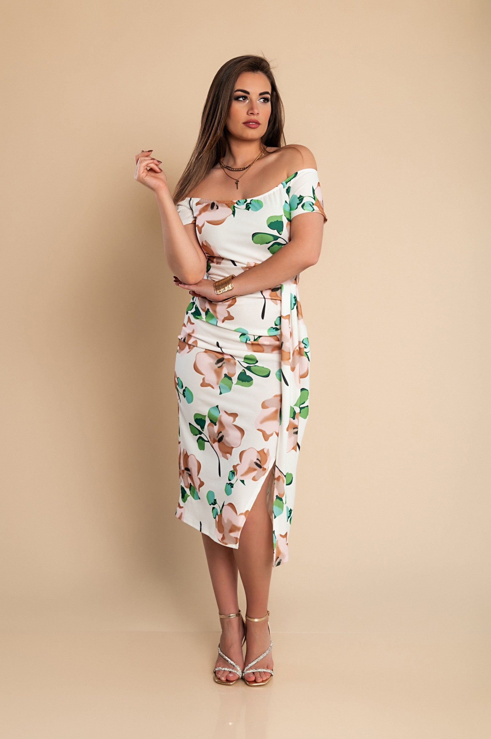 Elegant green midi dress with floral print, featuring a straight neckline and wrap skirt.