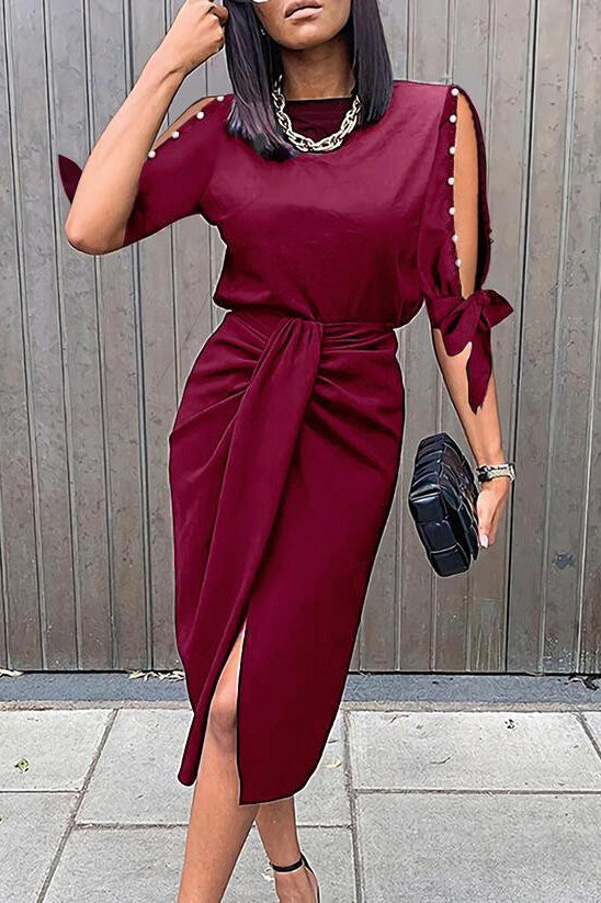 Elegant burgundy midi dress with pearl detail, featuring a round neckline and 3/4 sleeves, designed for comfort and style.