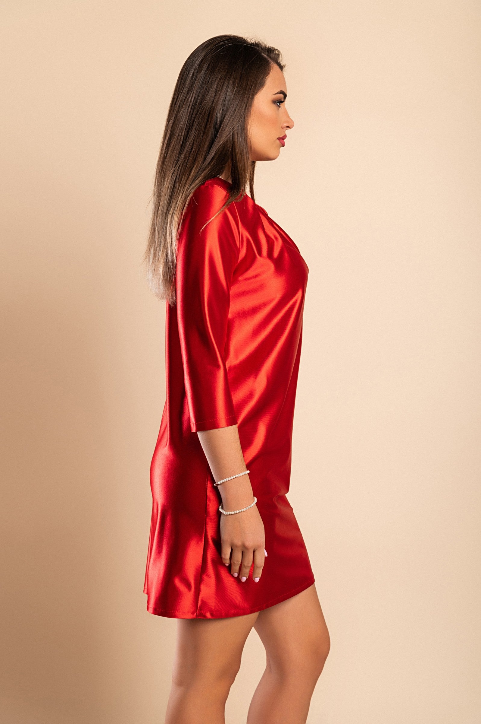 Elegant red mini dress made of imitation satin with round neckline and 3/4 sleeves, showcasing a loose fit and mid-thigh length.