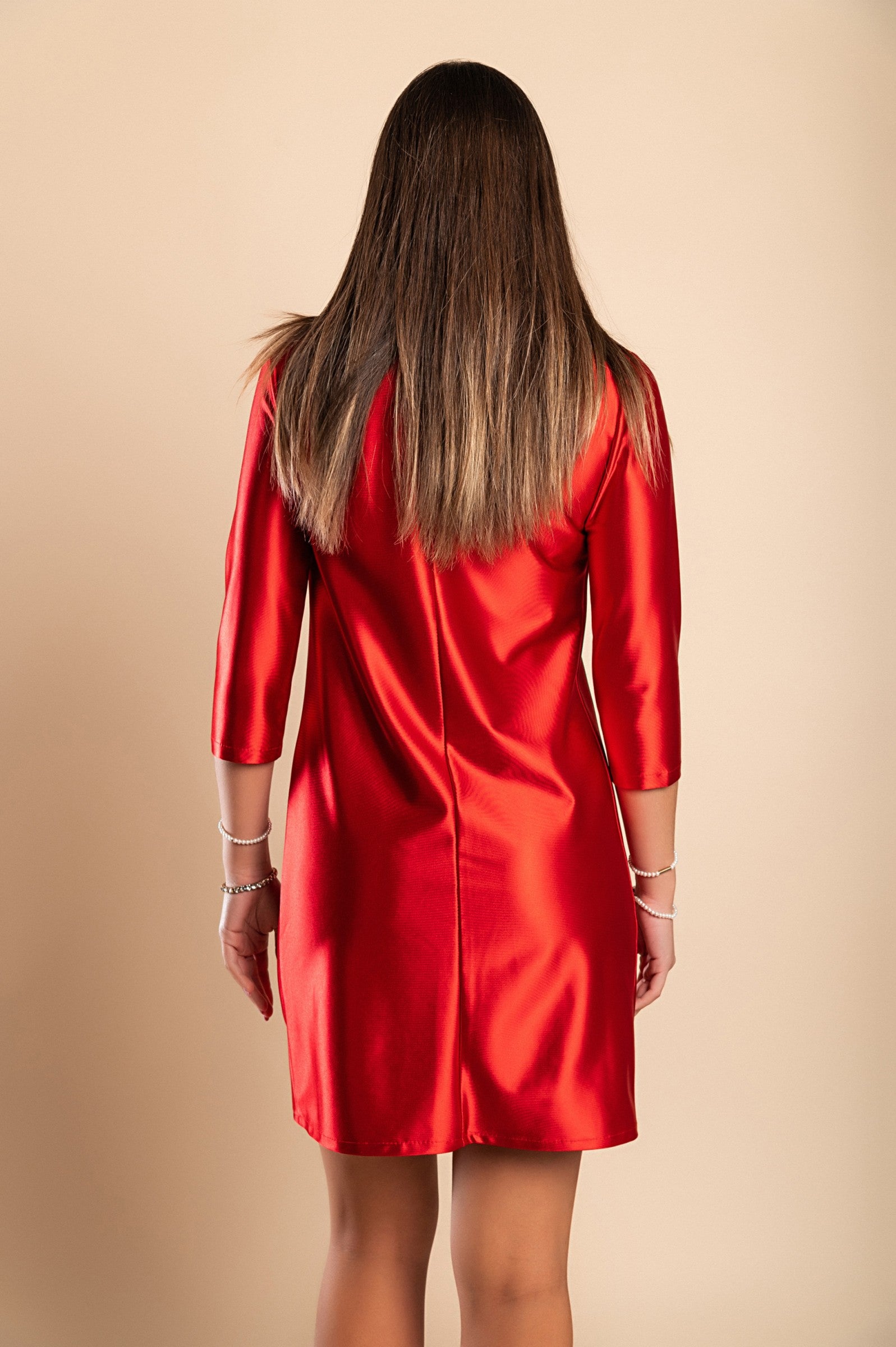 Elegant red mini dress made of imitation satin with round neckline and 3/4 sleeves, showcasing a loose fit and mid-thigh length.