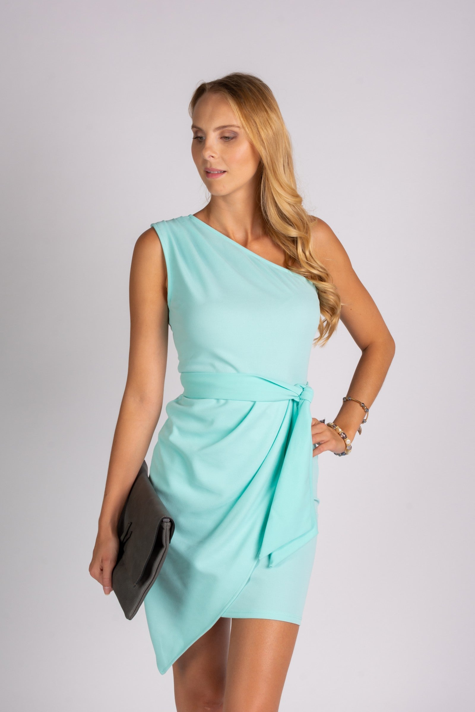 Elegant mini dress with one strap and a folding skirt, showcasing a stylish design and decorative belt.