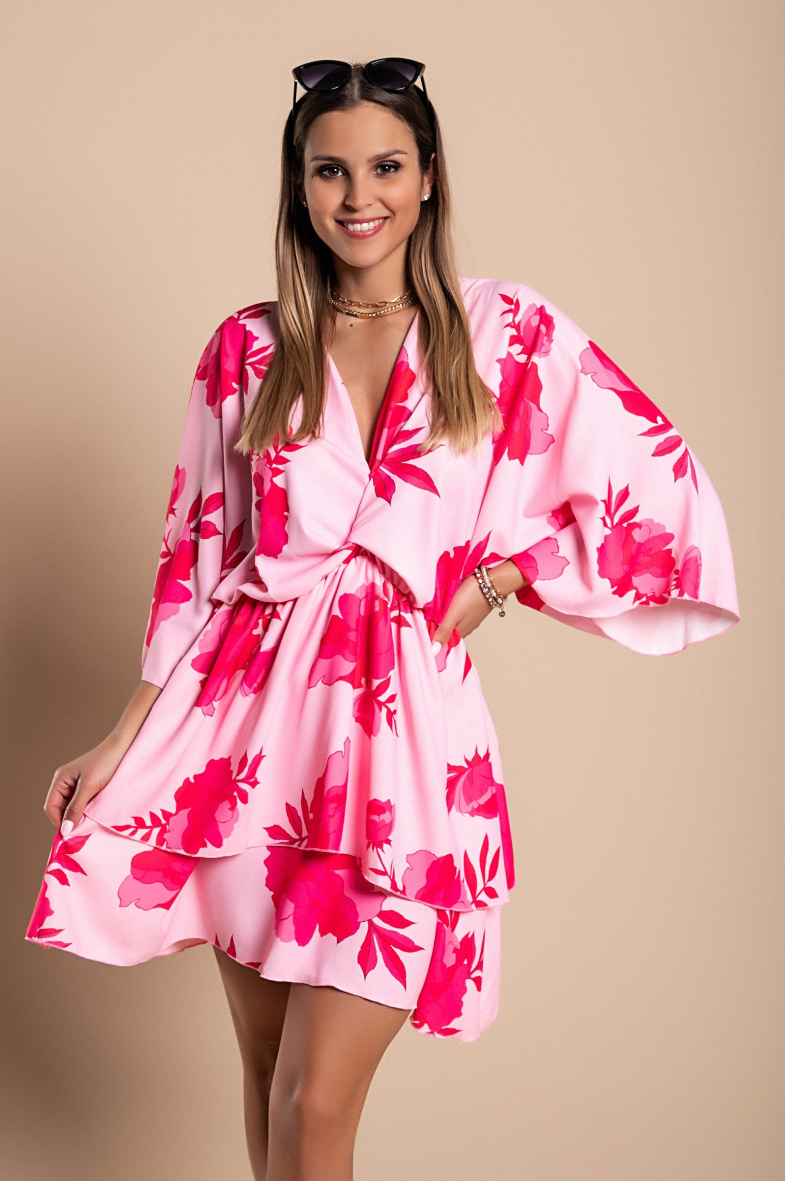 Elegant pink mini dress Amasena with print, featuring a deep neckline, loose sleeves, elastic waist, and ruffled skirt.