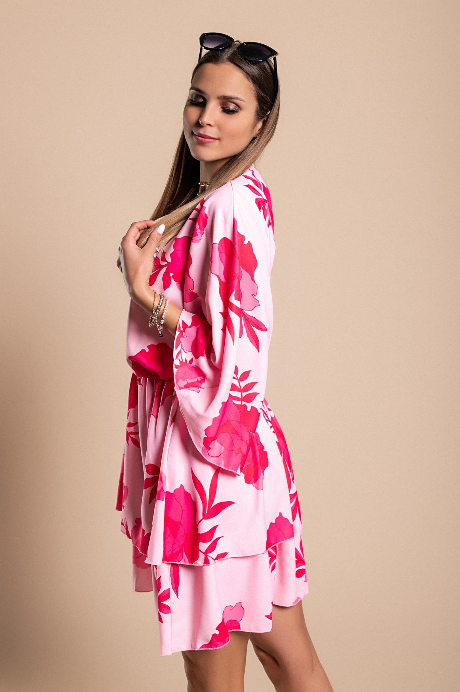 Elegant pink mini dress Amasena with print, featuring a deep neckline, loose sleeves, elastic waist, and ruffled skirt.