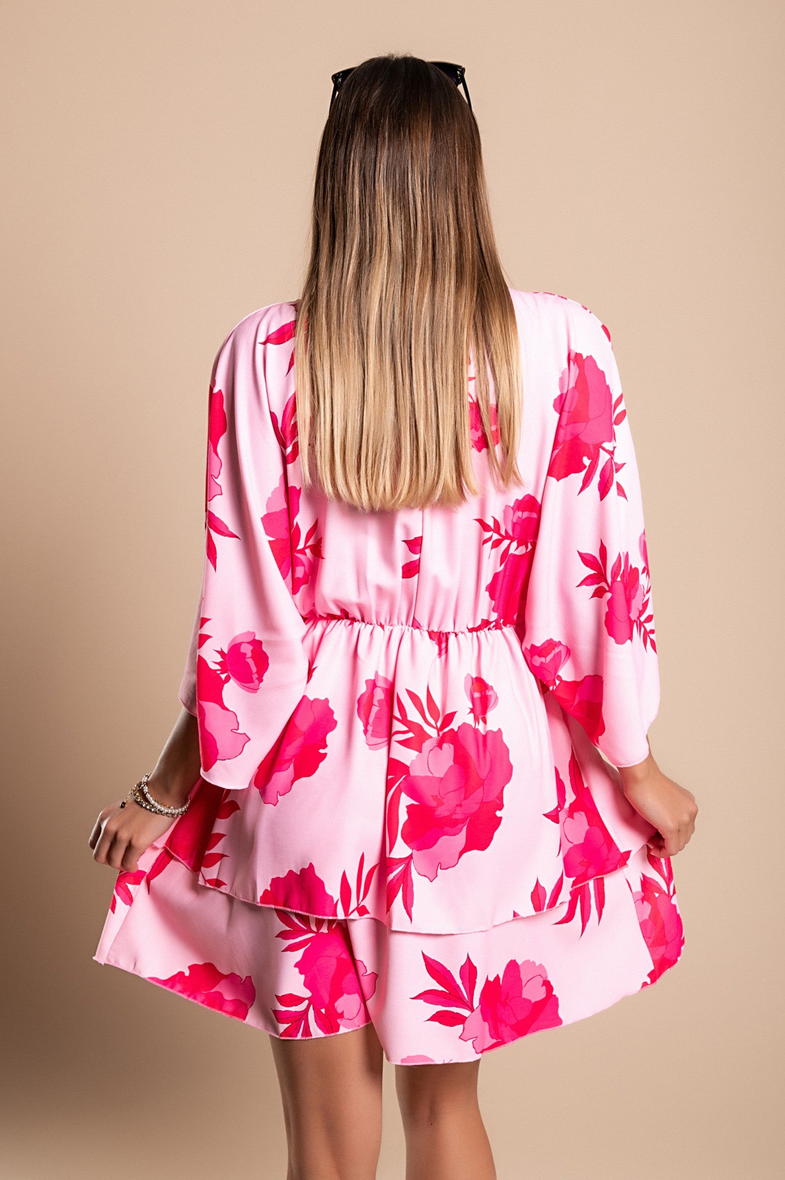 Elegant pink mini dress Amasena with print, featuring a deep neckline, loose sleeves, elastic waist, and ruffled skirt.