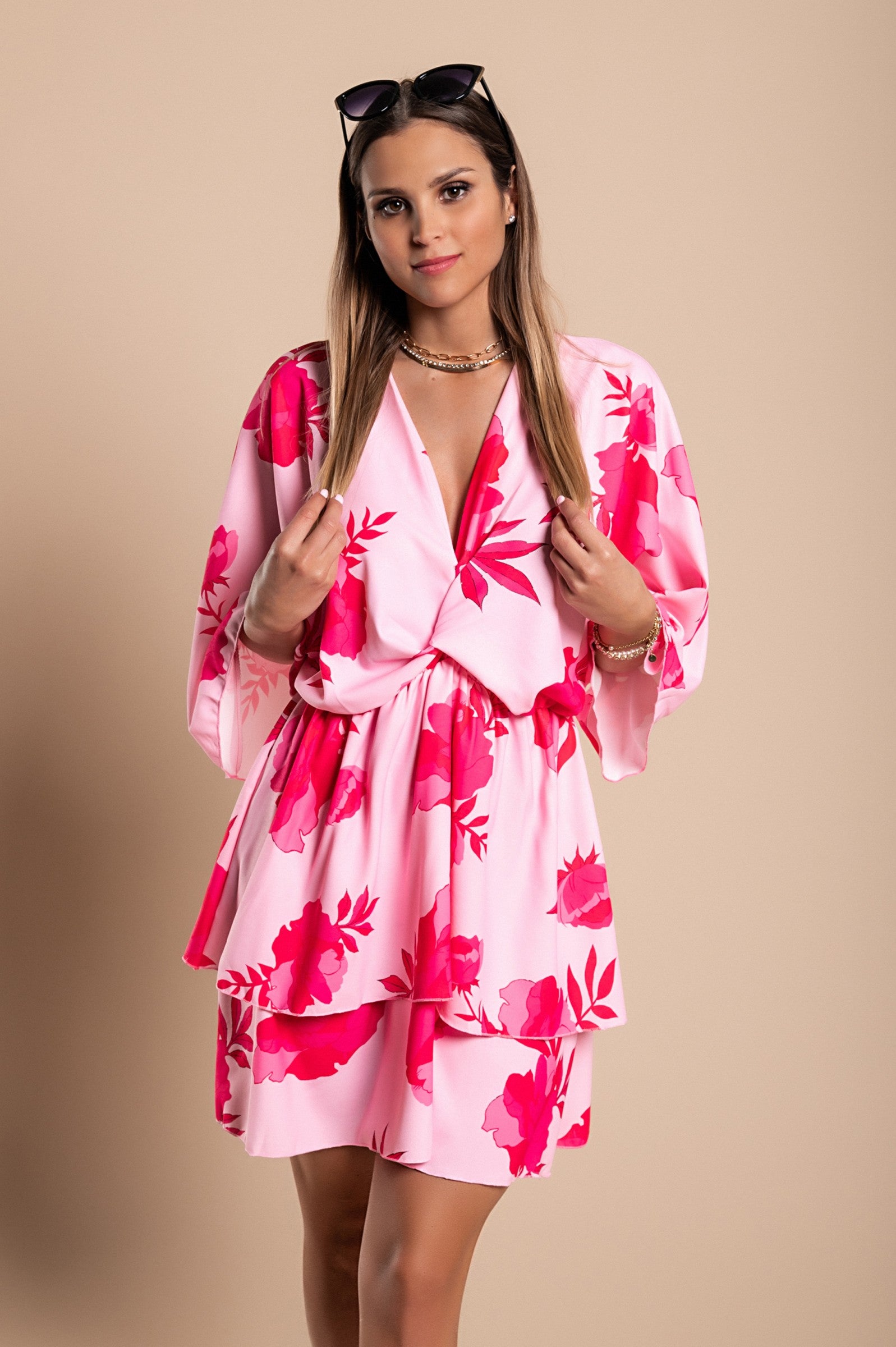 Elegant pink mini dress Amasena with print, featuring a deep neckline, loose sleeves, elastic waist, and ruffled skirt.