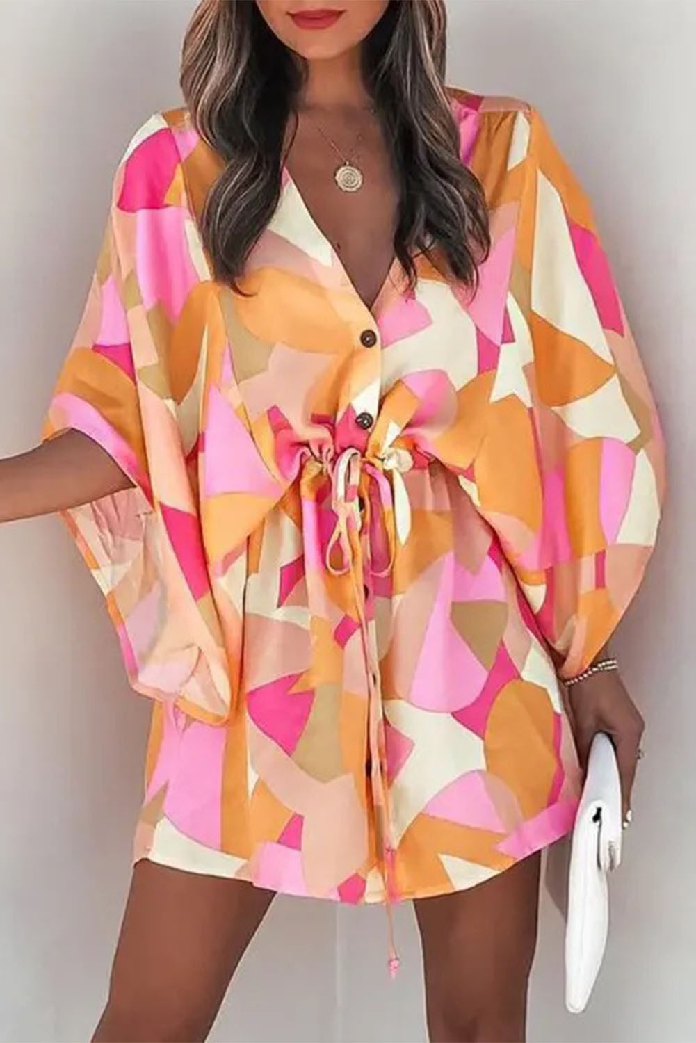 Elegant pink mini dress with print featuring a deep V-neckline, puff sleeves, and button-up front closure.