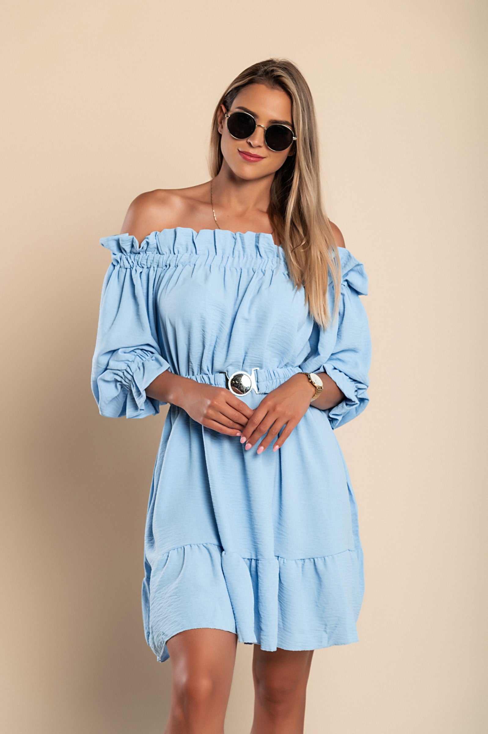 Elegant light blue mini dress with ruffles, featuring a bateau neckline and long sleeves, designed for comfort and style.