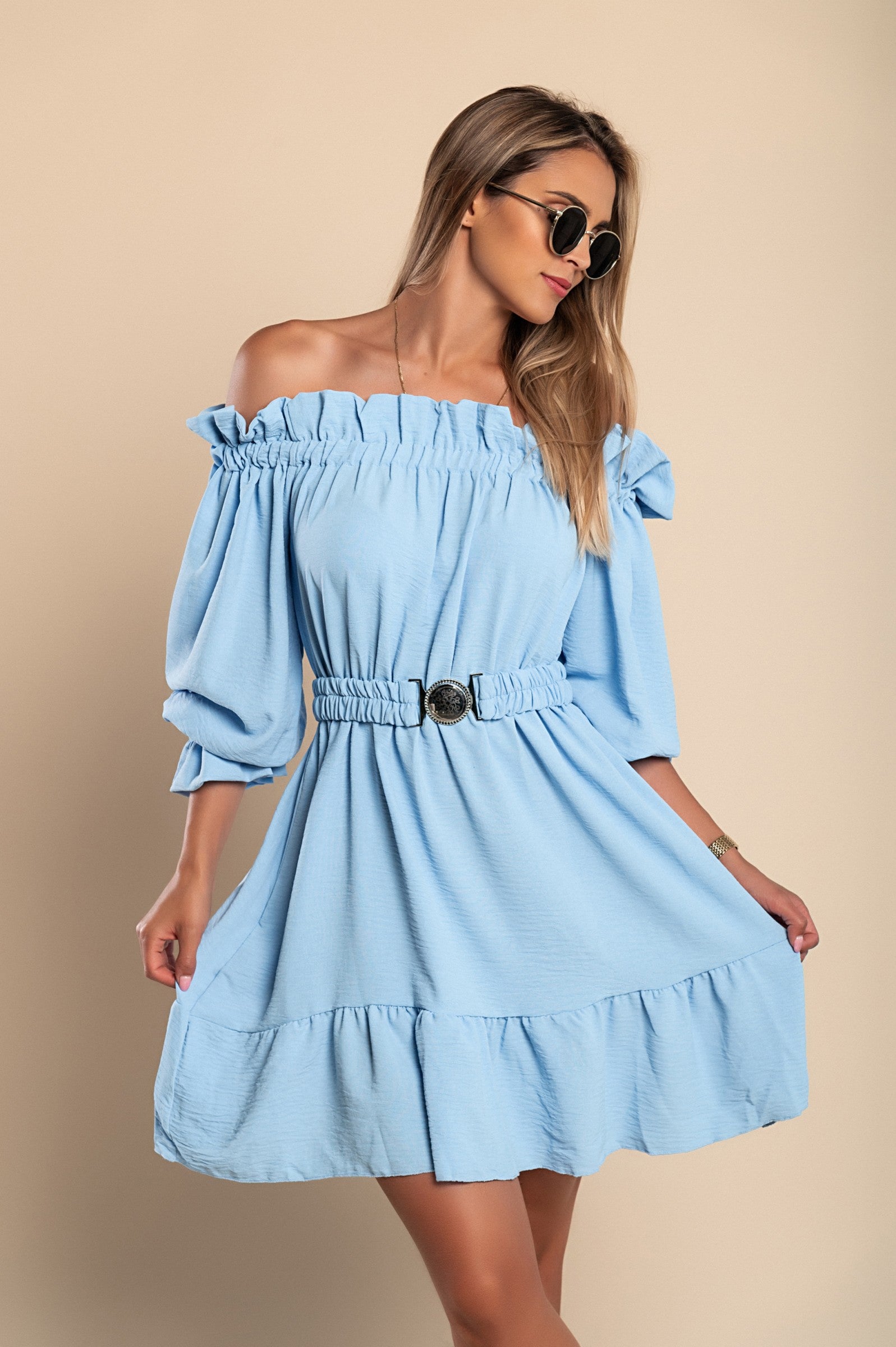 Elegant light blue mini dress with ruffles, featuring a bateau neckline and long sleeves, designed for comfort and style.