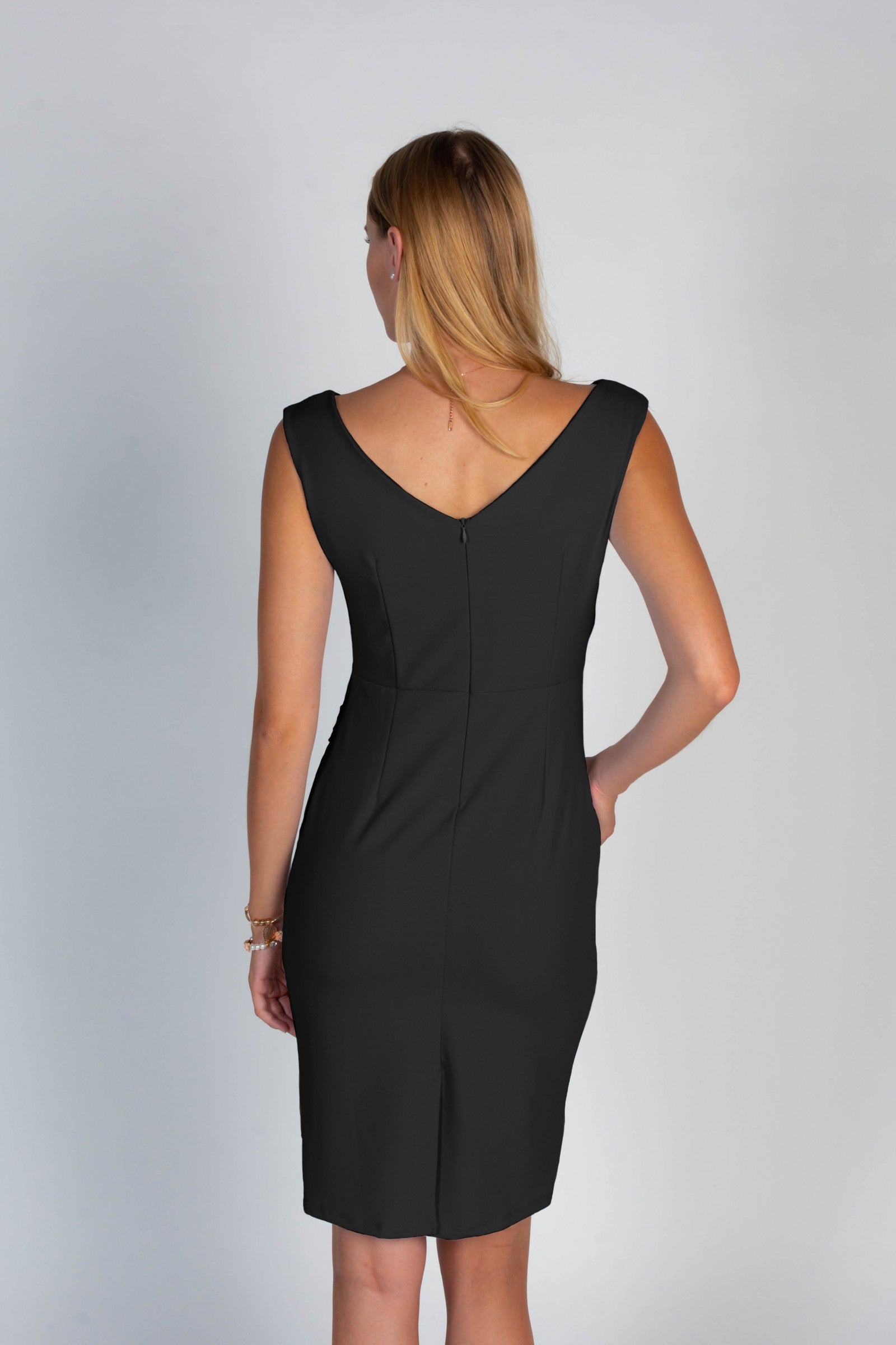 Elegant mini sleeveless dress with gathered detail, featuring an asymmetrical 'v' neckline and pleated wing detail, made in Italy.