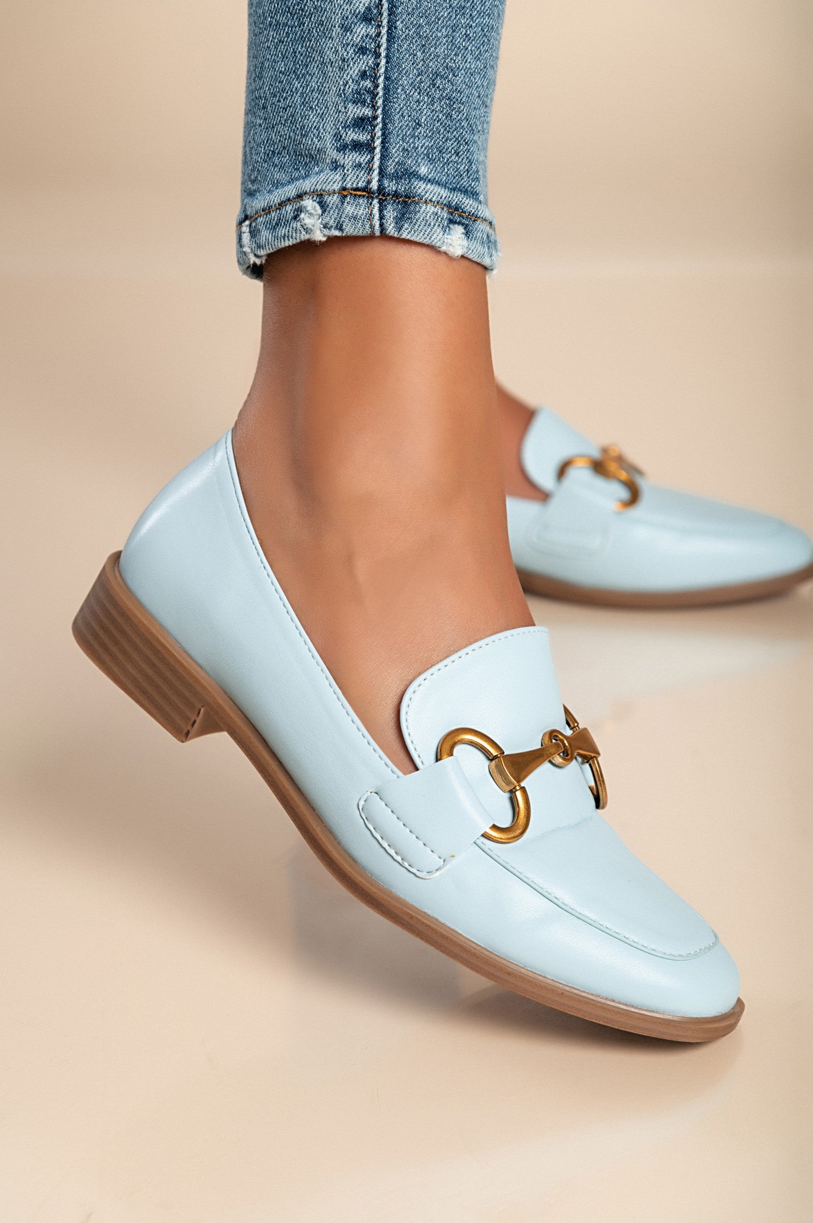 Elegant light blue moccasins with decorative detail and flat sole, model V7T88801.